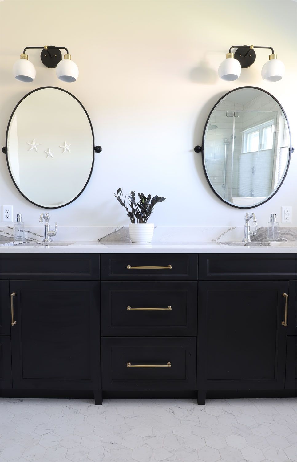 A bathroom with two sinks and two mirrors.