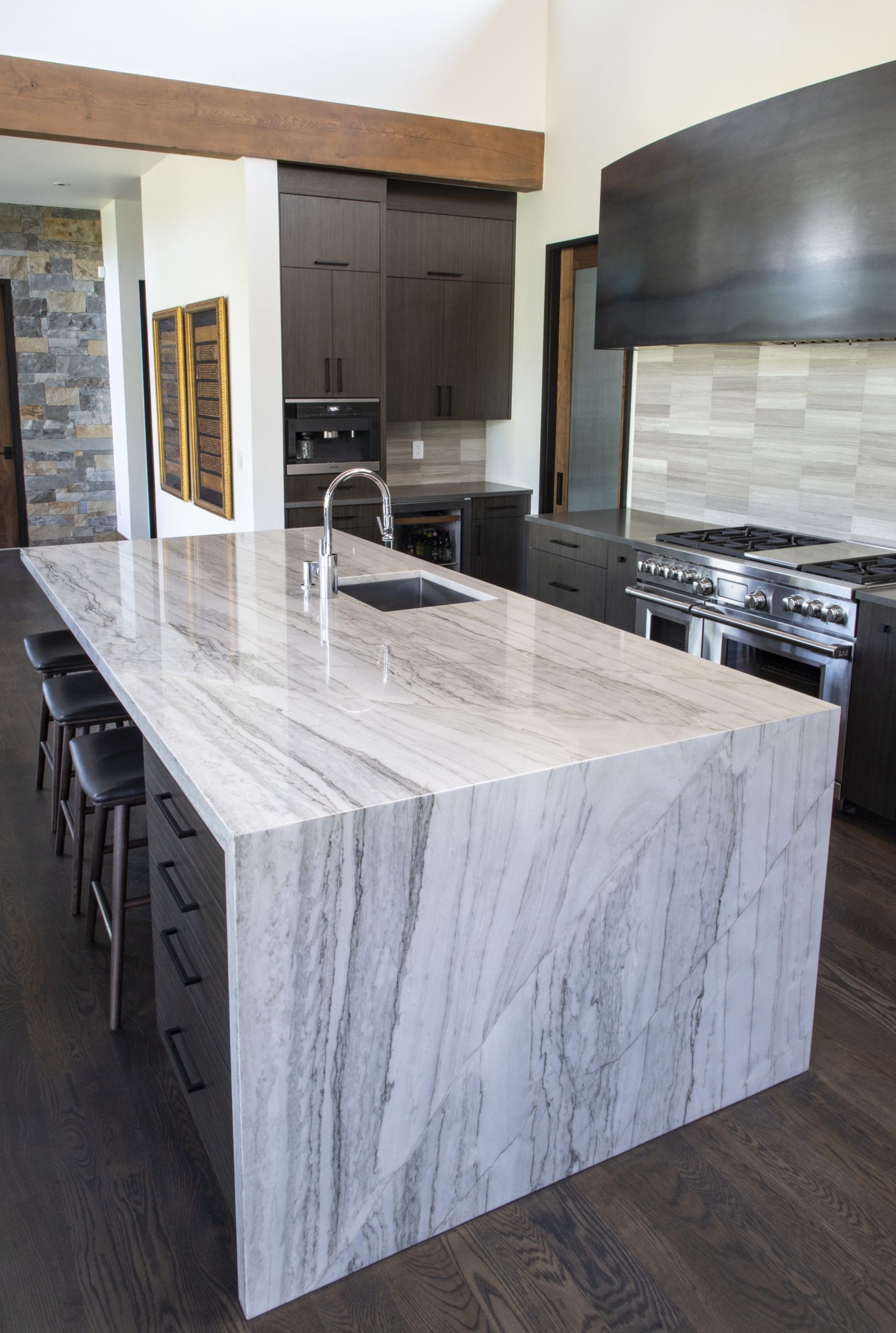 A kitchen with a large island and a sink.