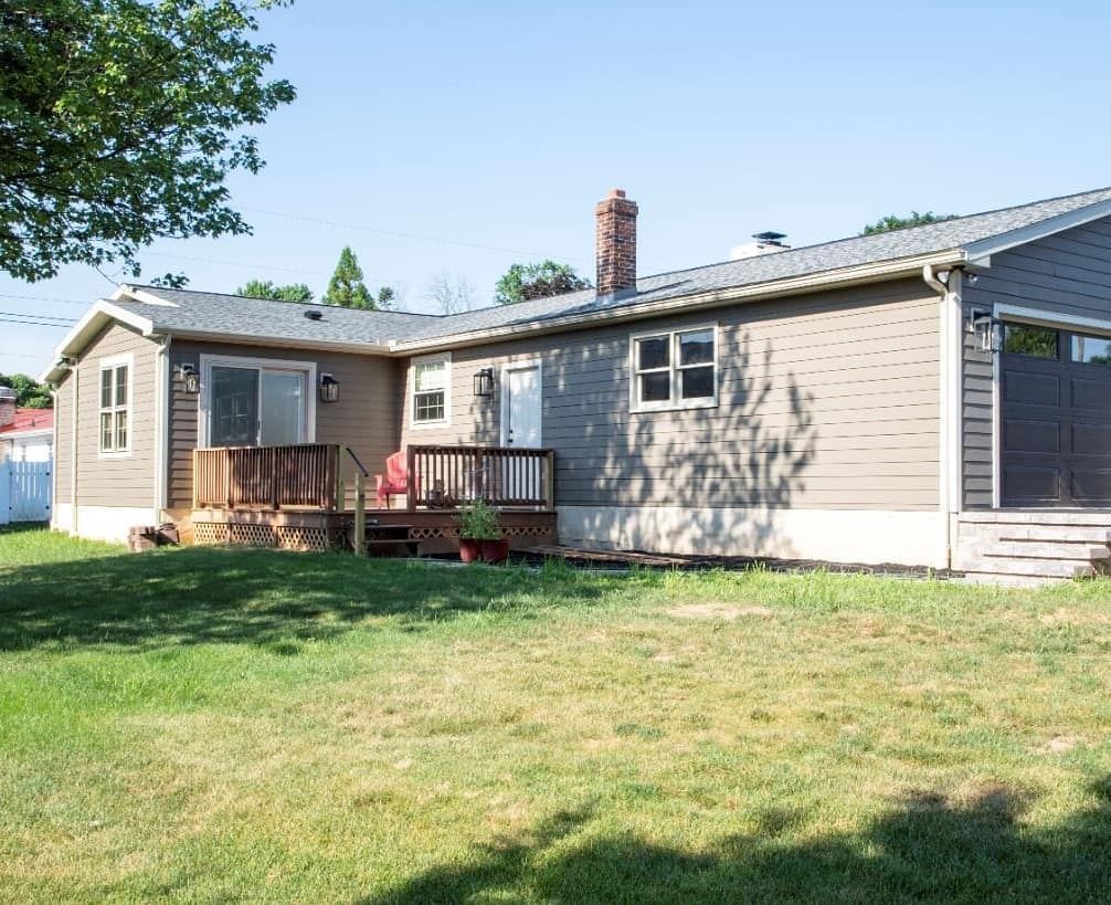 A house with a large lawn in front of it