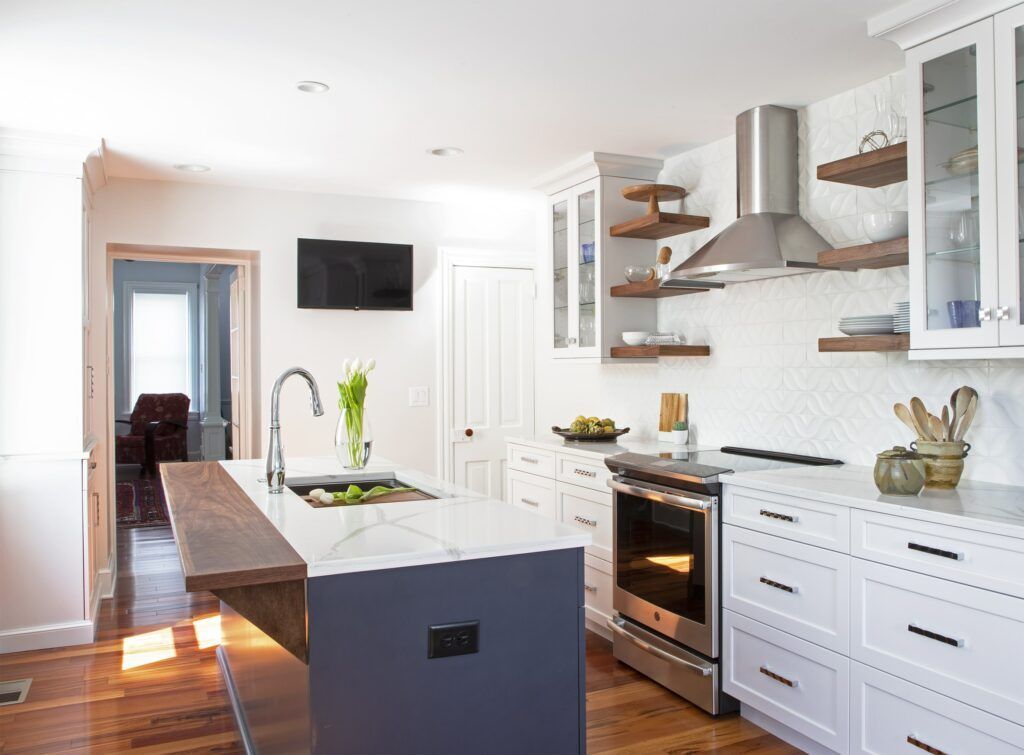 A kitchen with white cabinets and stainless steel appliances