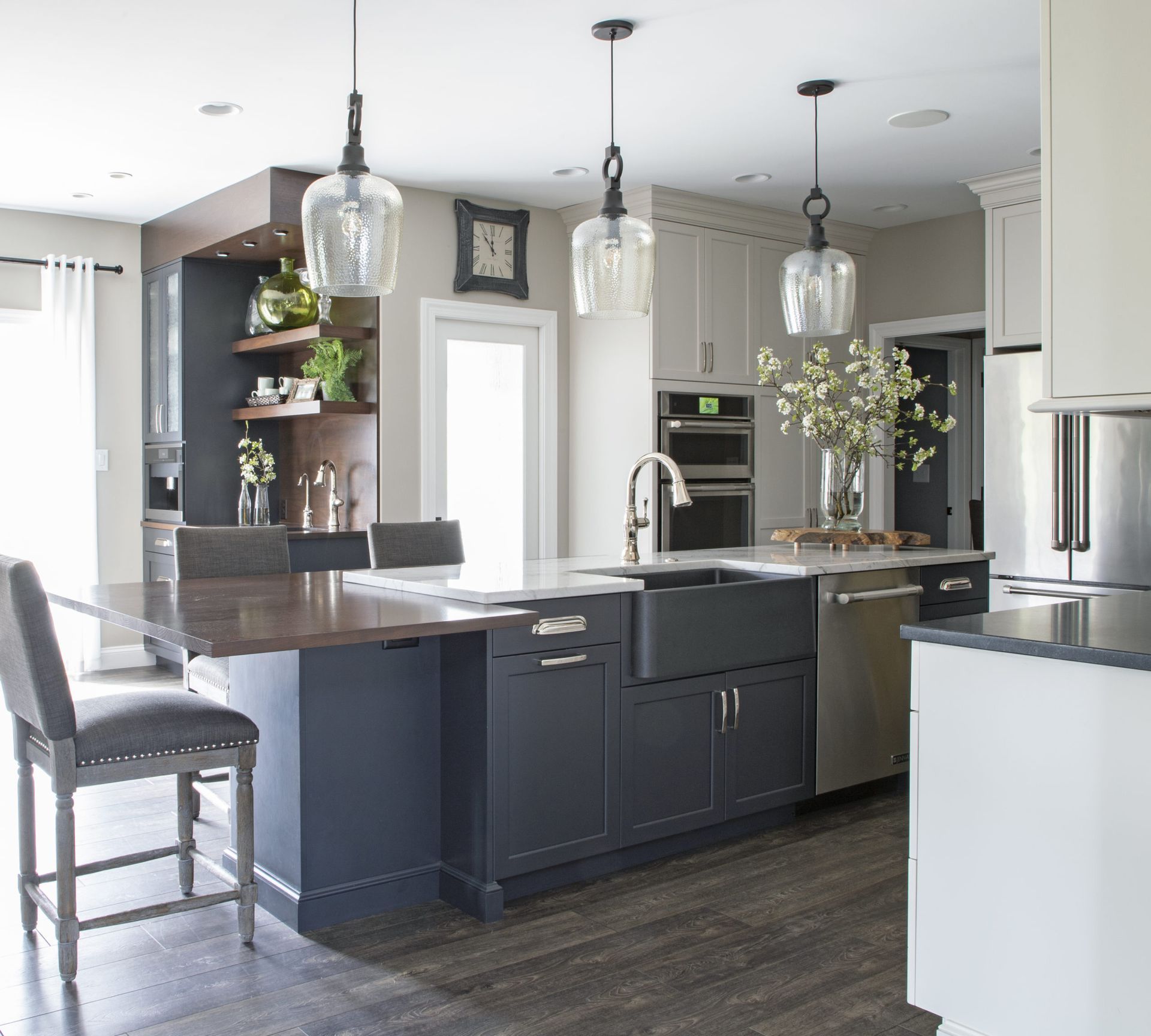 A kitchen with black cabinets and stainless steel appliances