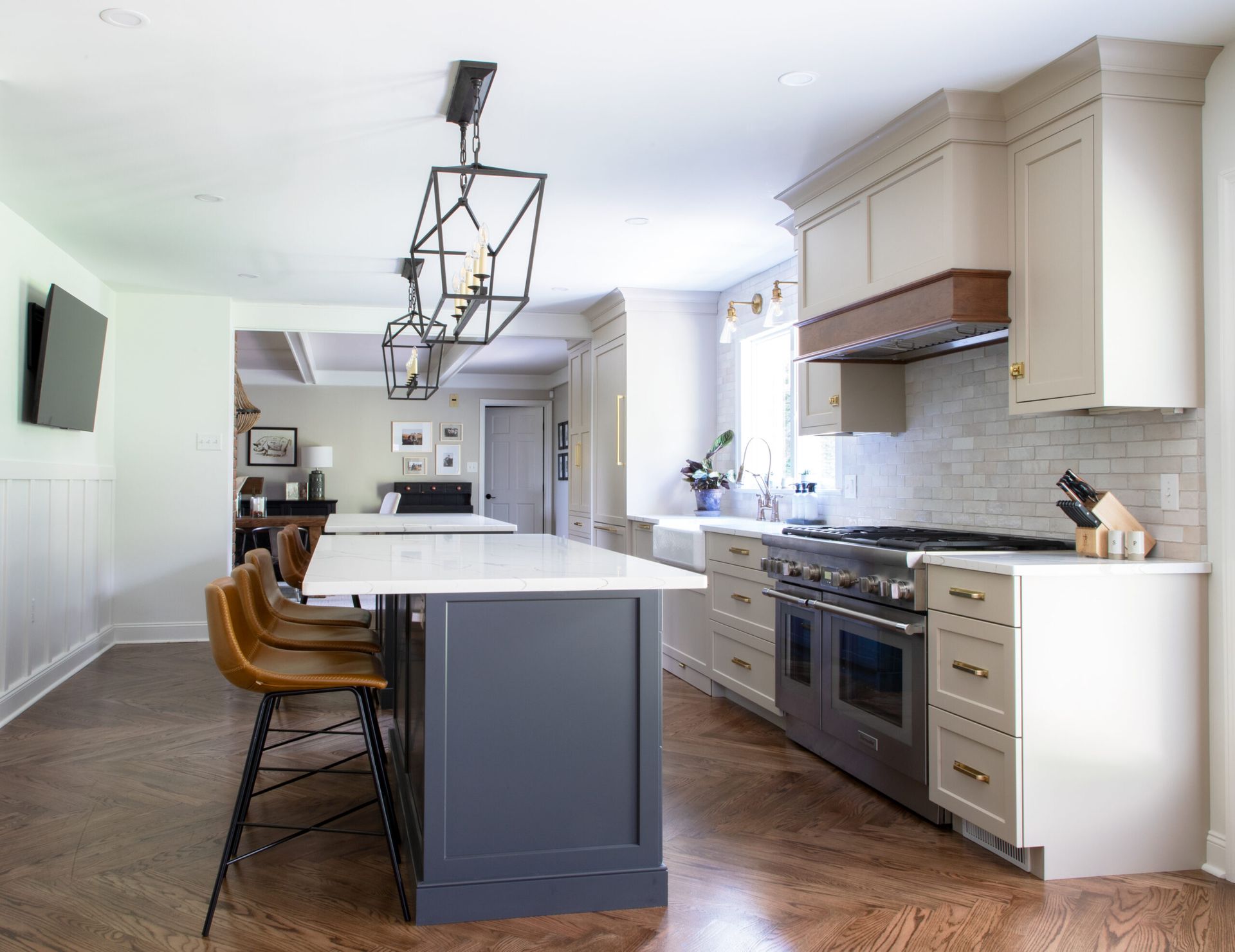 A kitchen with a large island in the middle and stainless steel appliances.