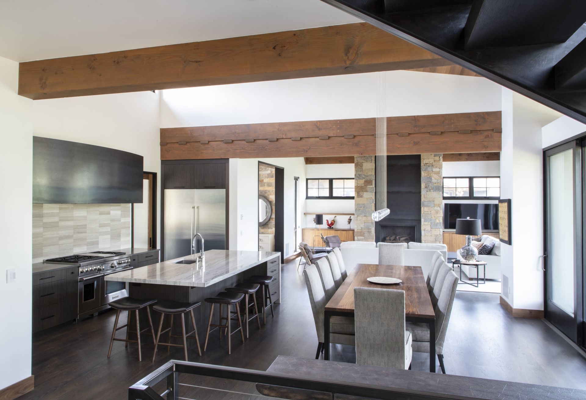 A kitchen with a large island and a dining table