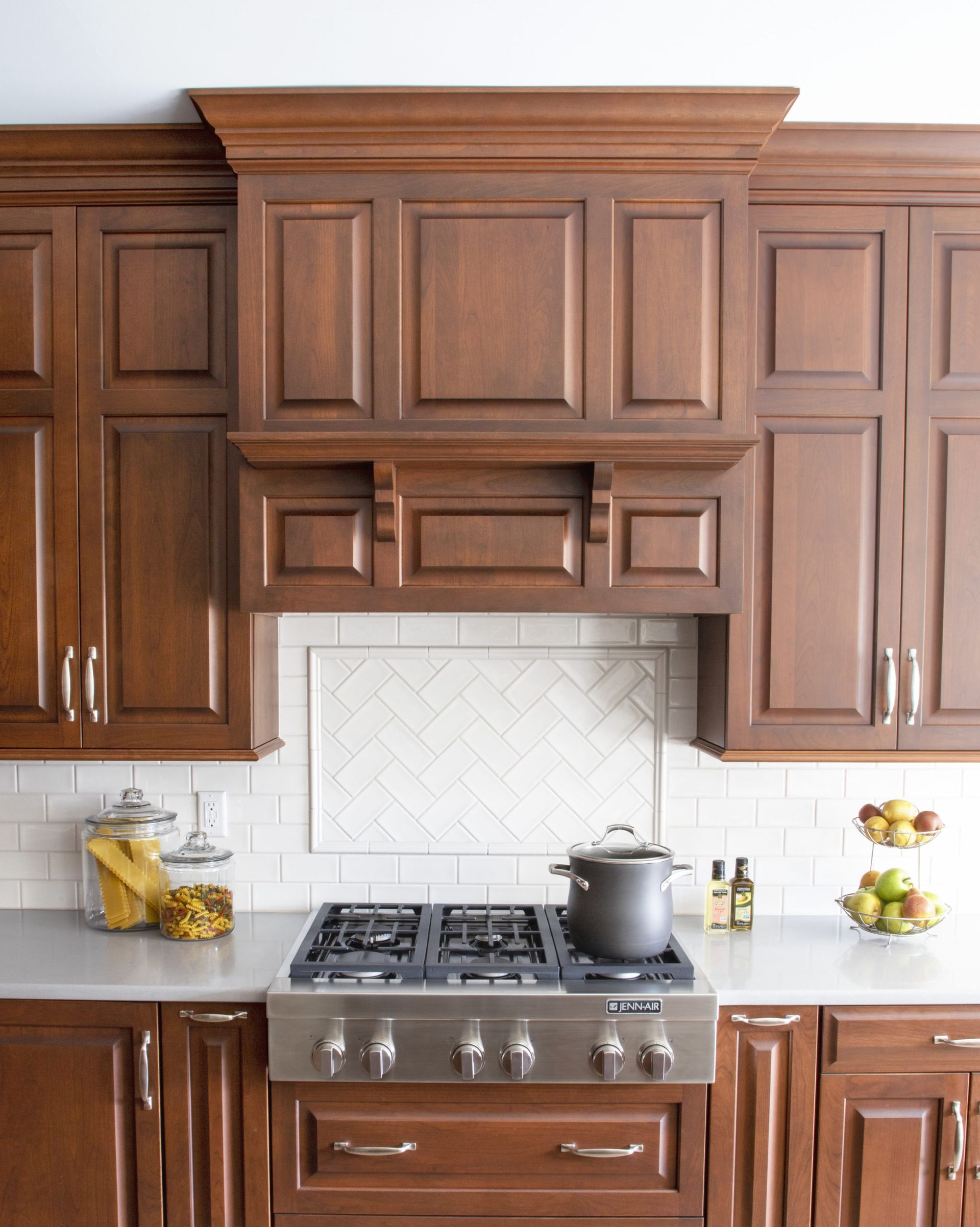 A kitchen with wooden cabinets and a stove top oven