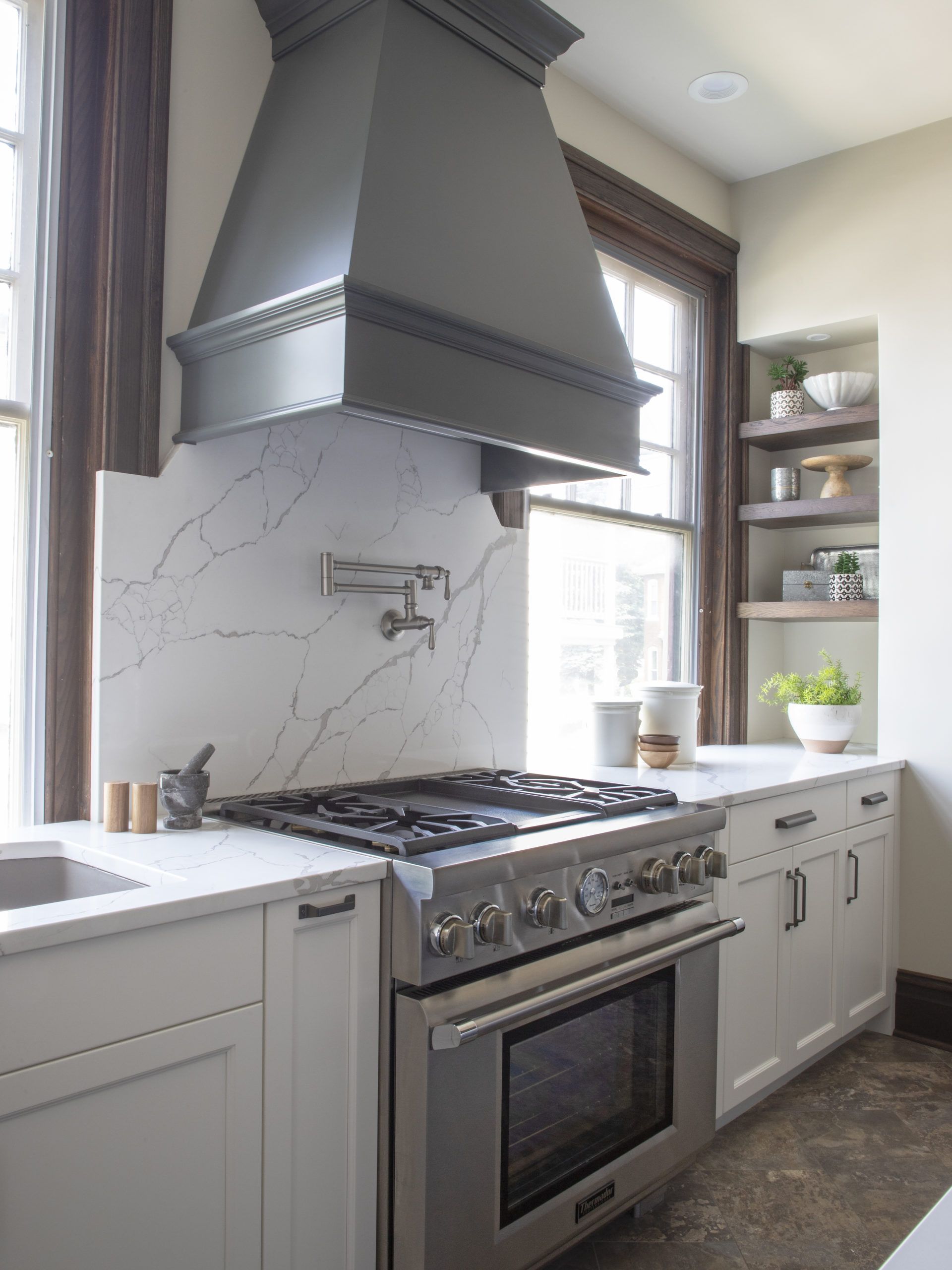 A kitchen with a stove top oven and a sink