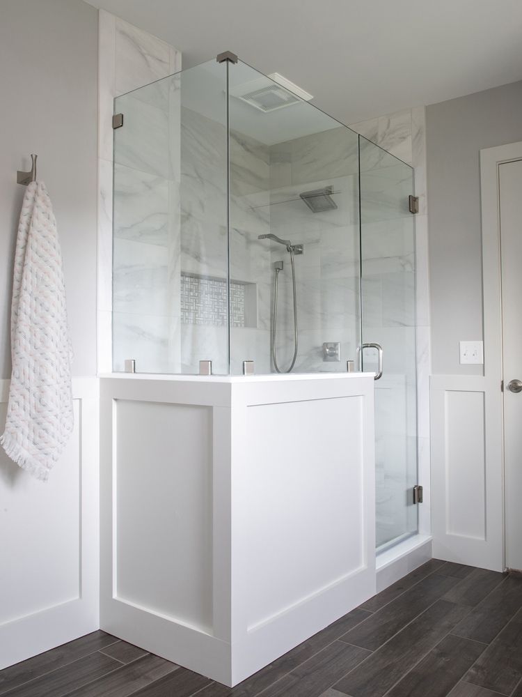 A bathroom with a walk in shower and a bathtub.