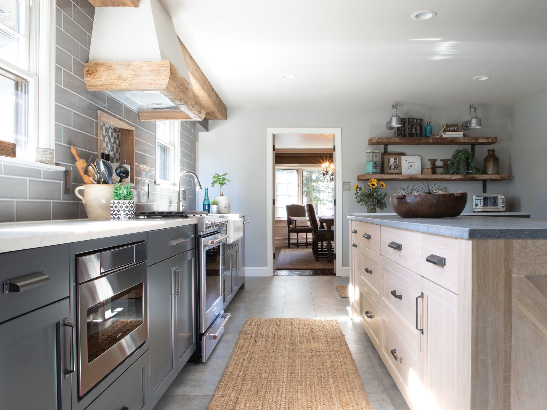 A kitchen with stainless steel appliances and wooden cabinets.
