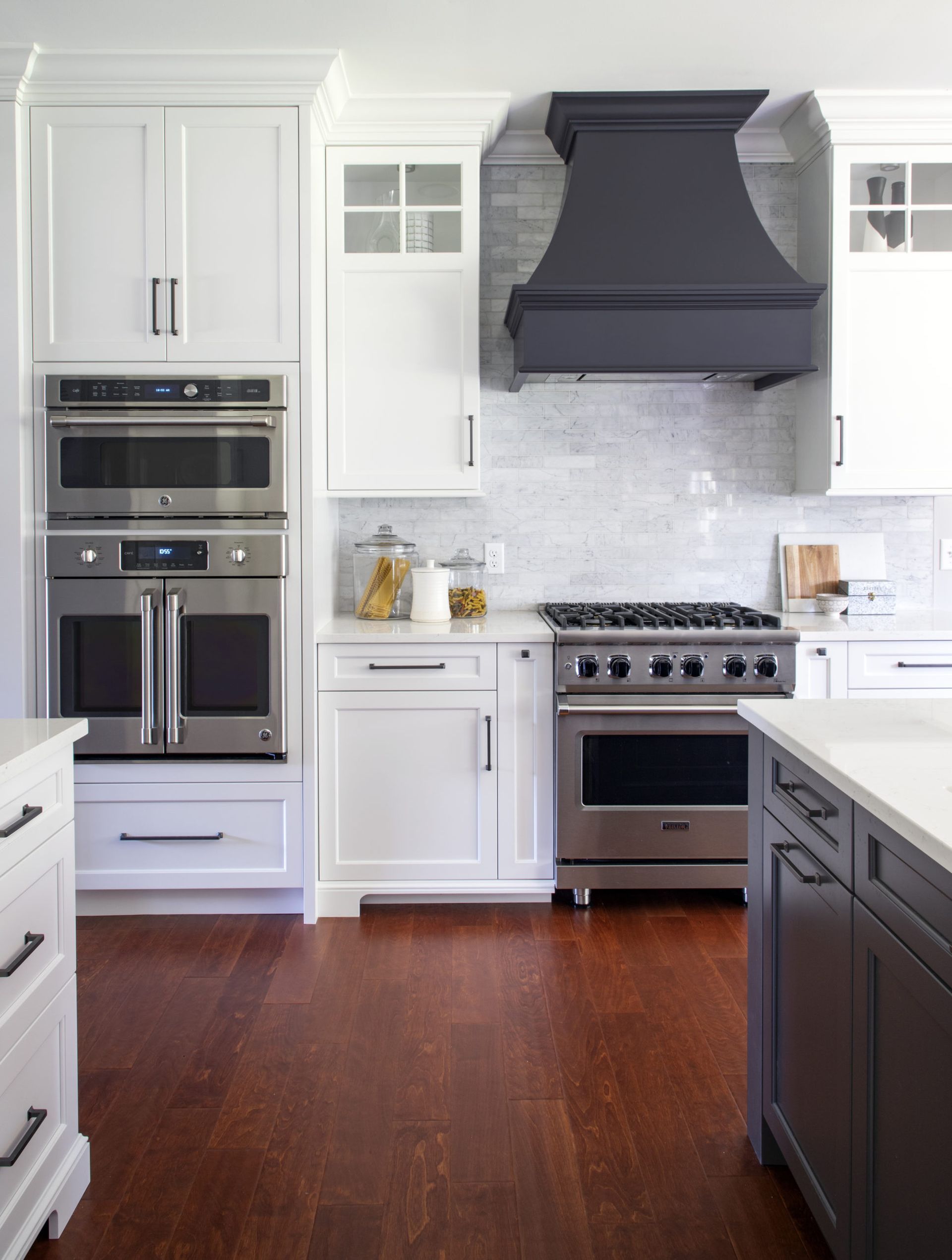 A kitchen with white cabinets and stainless steel appliances