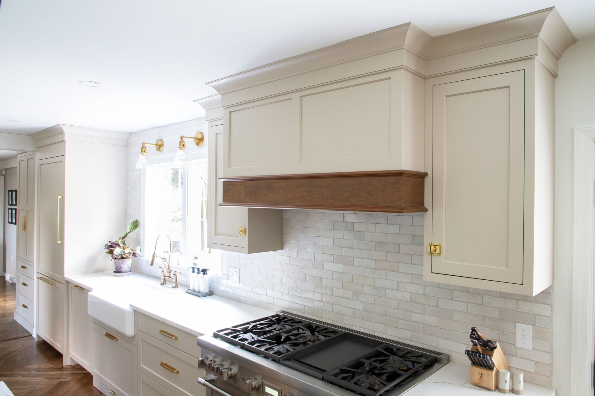 A kitchen with white cabinets and a stove top oven