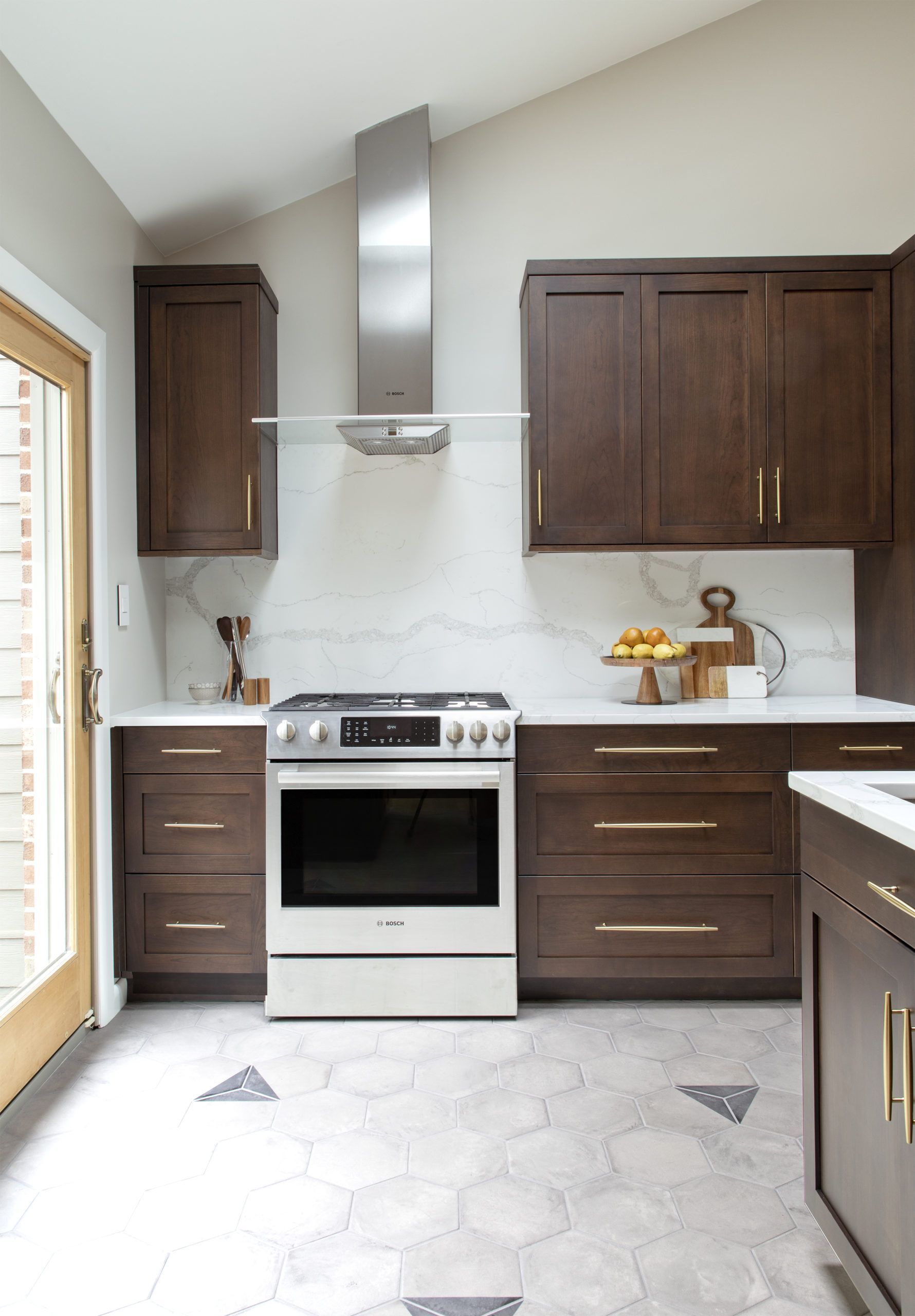 A kitchen with stainless steel appliances and wooden cabinets.