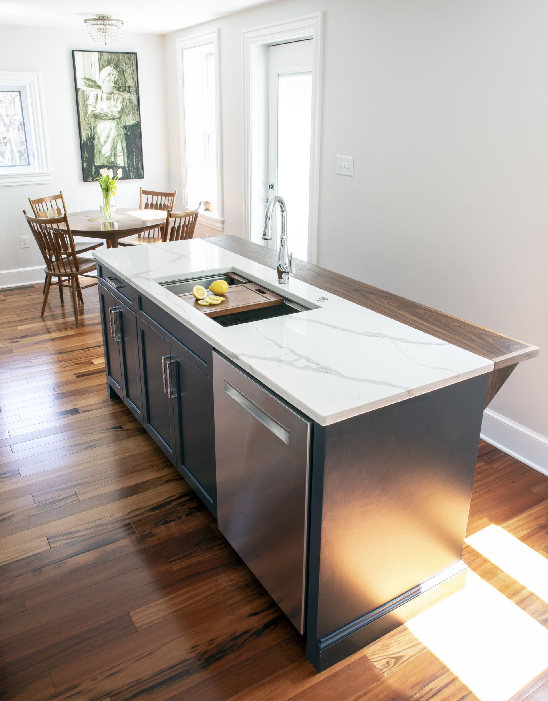 A kitchen with a large island and a sink.