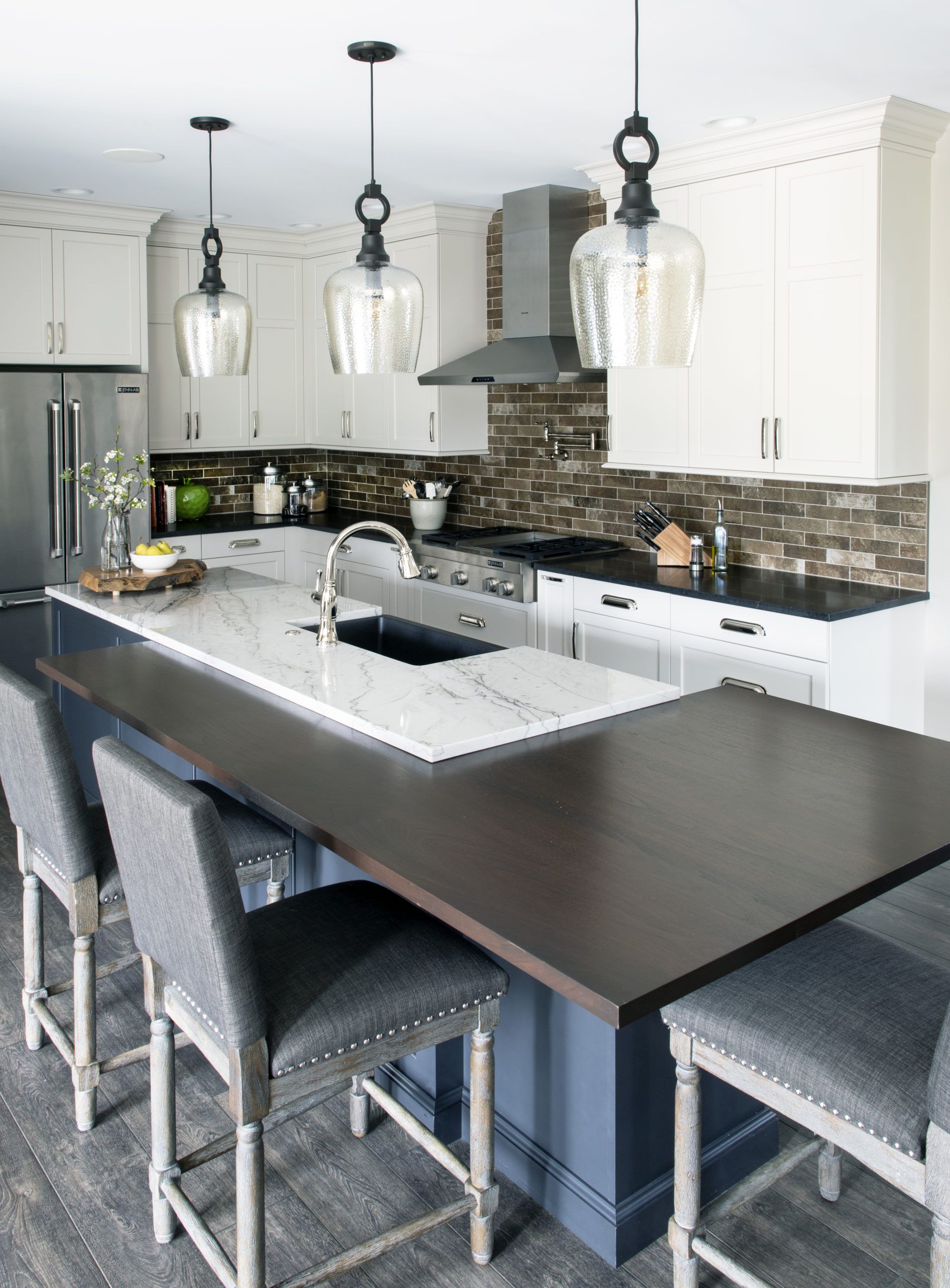 A kitchen with a large island and stools