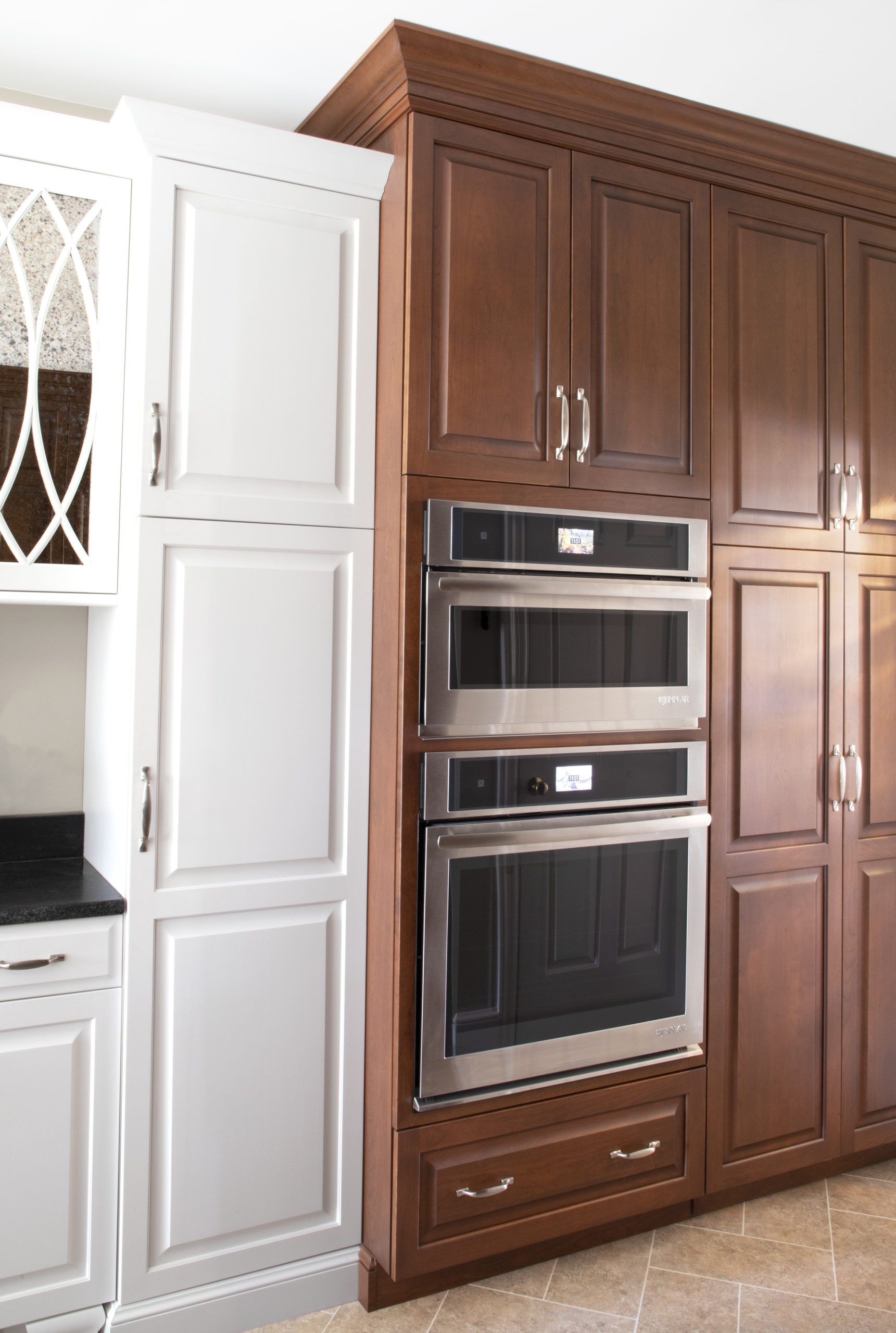 A kitchen with wooden cabinets and stainless steel appliances
