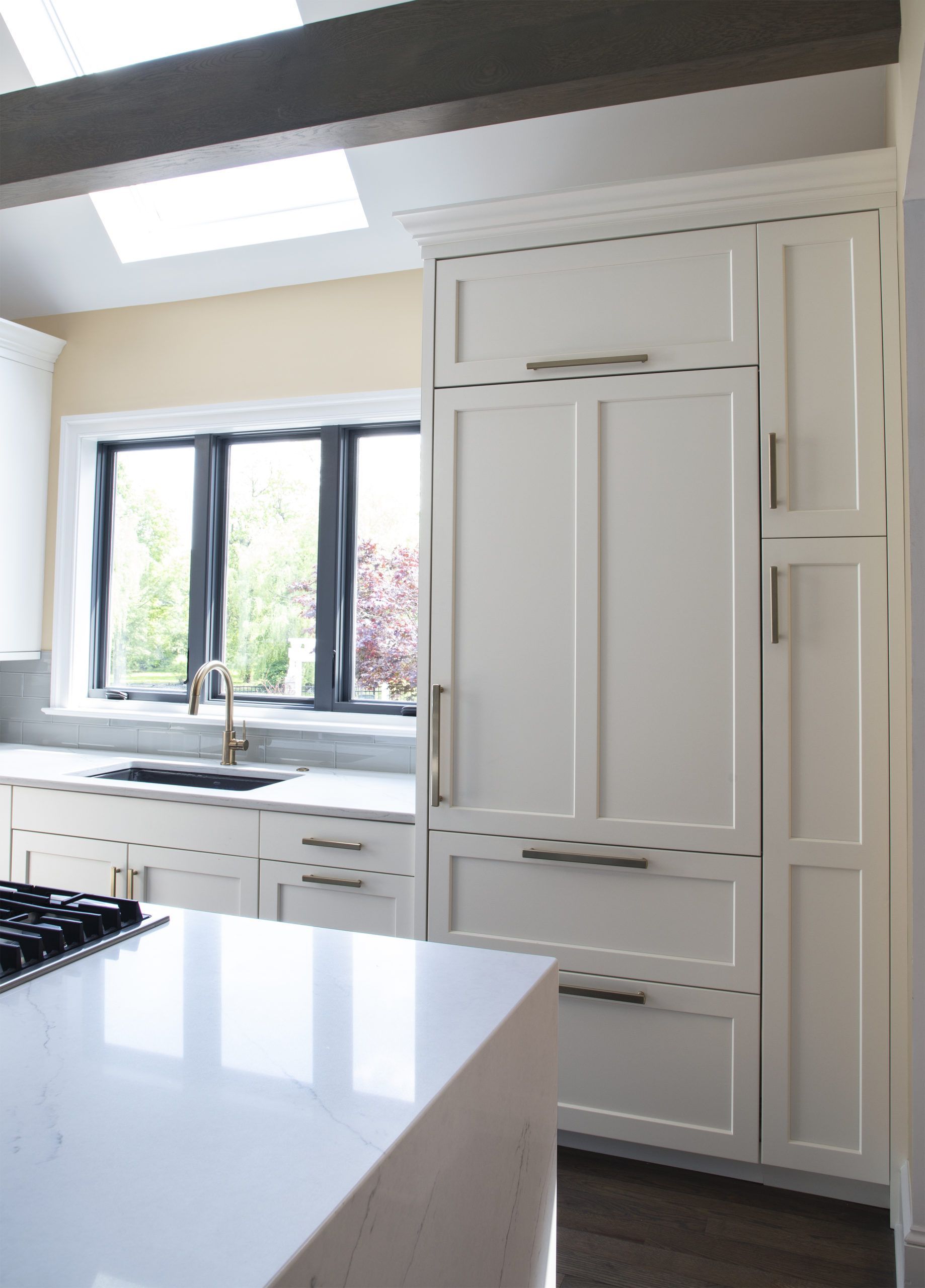 A kitchen with white cabinets and a stove top oven