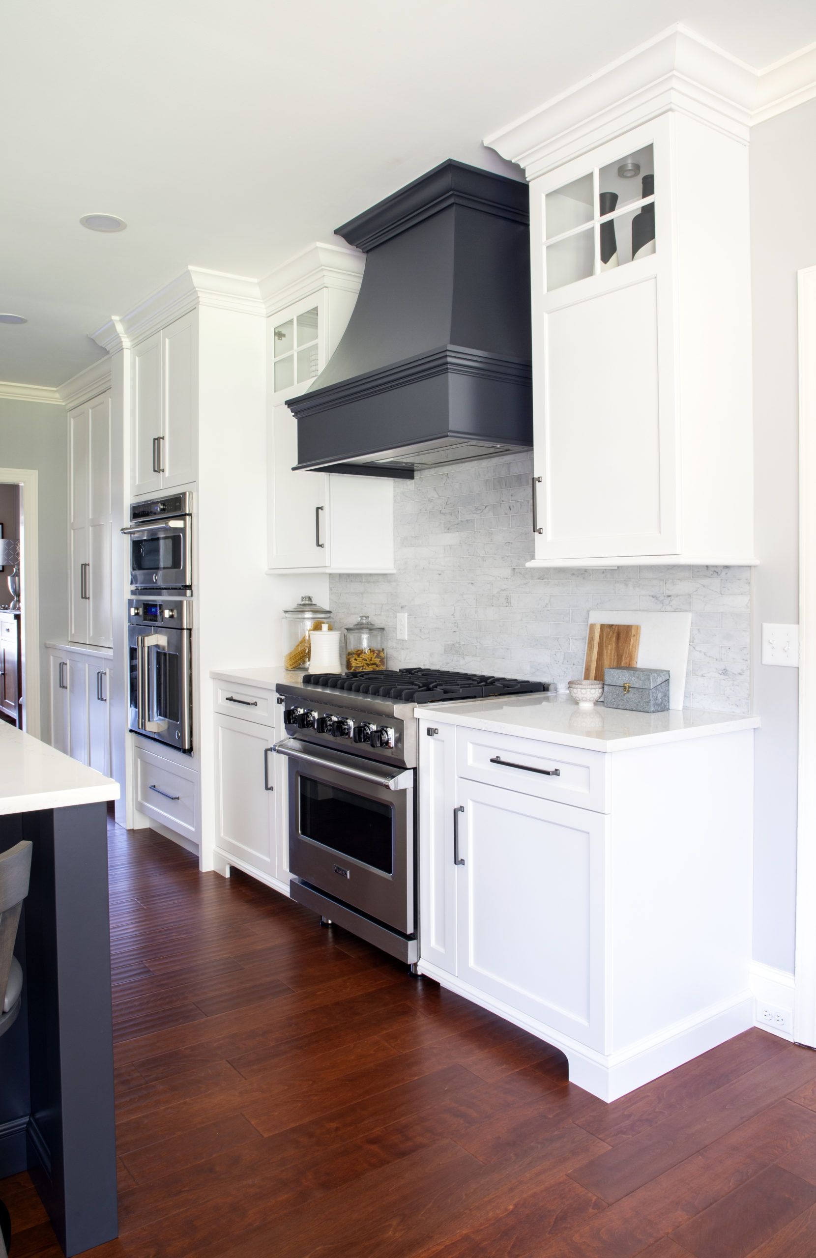 A kitchen with white cabinets and stainless steel appliances.