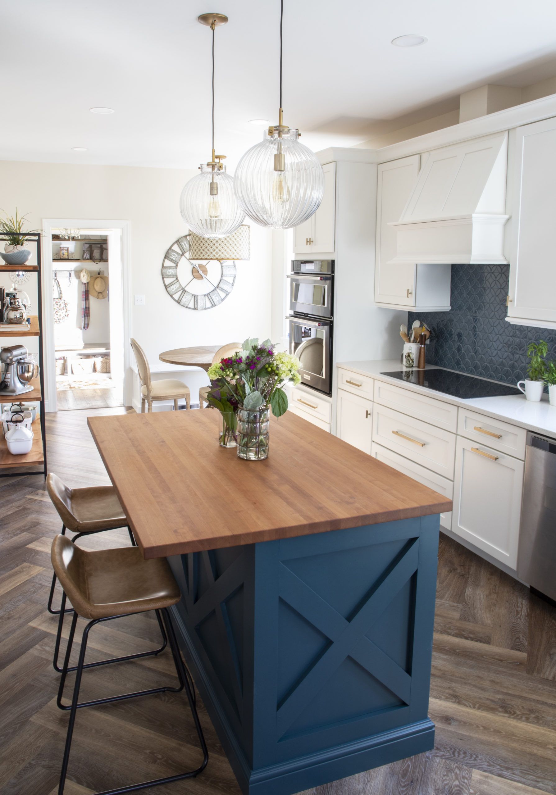 A kitchen with a large island and a wooden table.