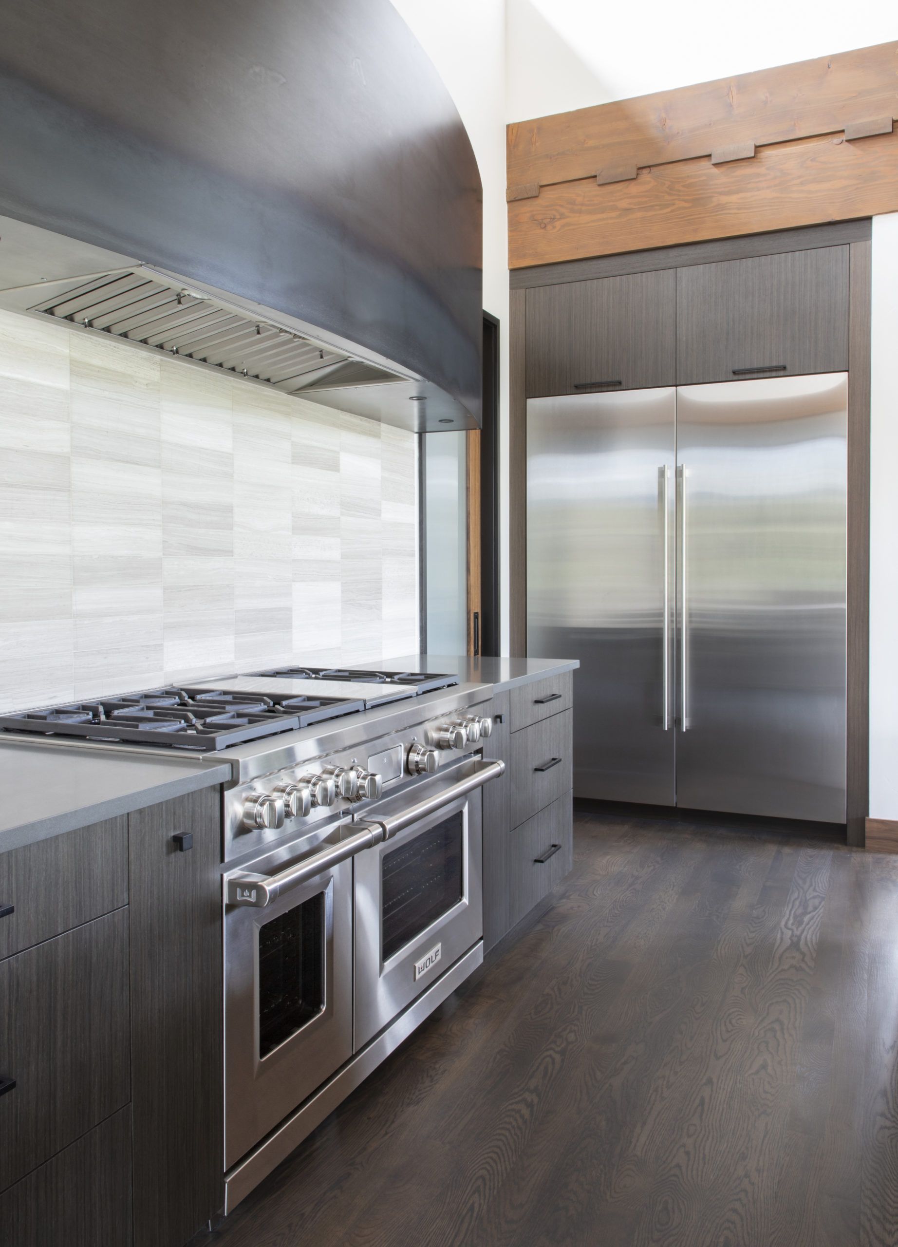 A kitchen with a stove top oven and a refrigerator