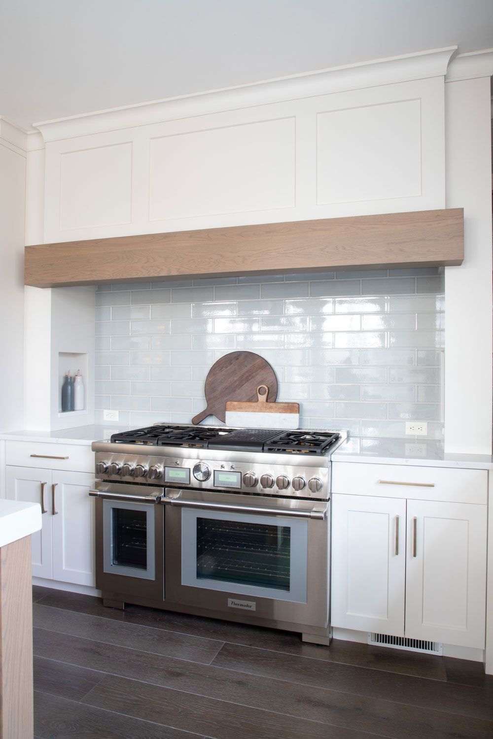 A kitchen with stainless steel appliances and white cabinets