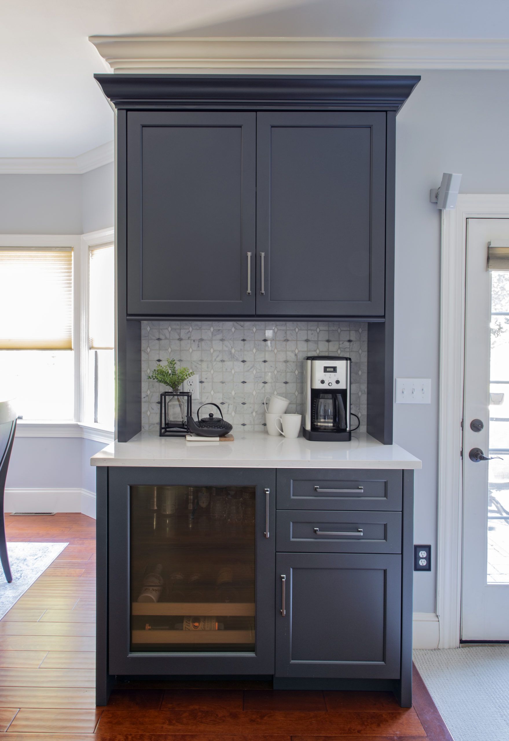 A kitchen with a coffee maker and a wine cooler