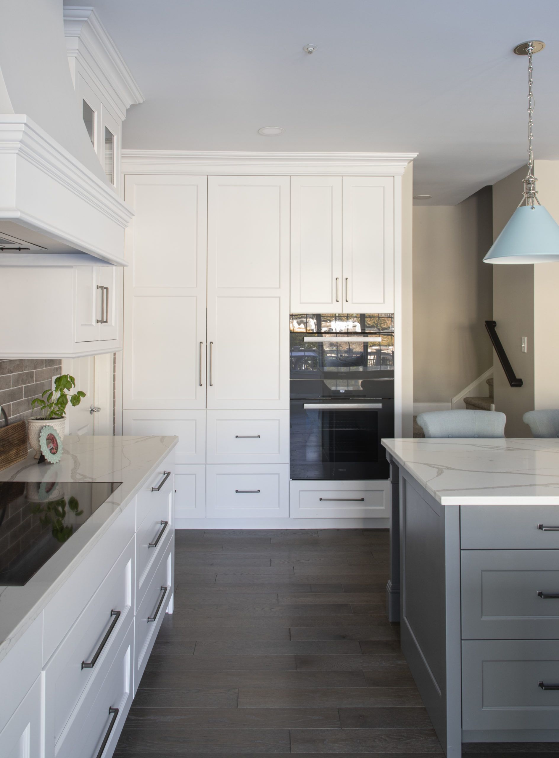 A kitchen with white cabinets and a stove top oven
