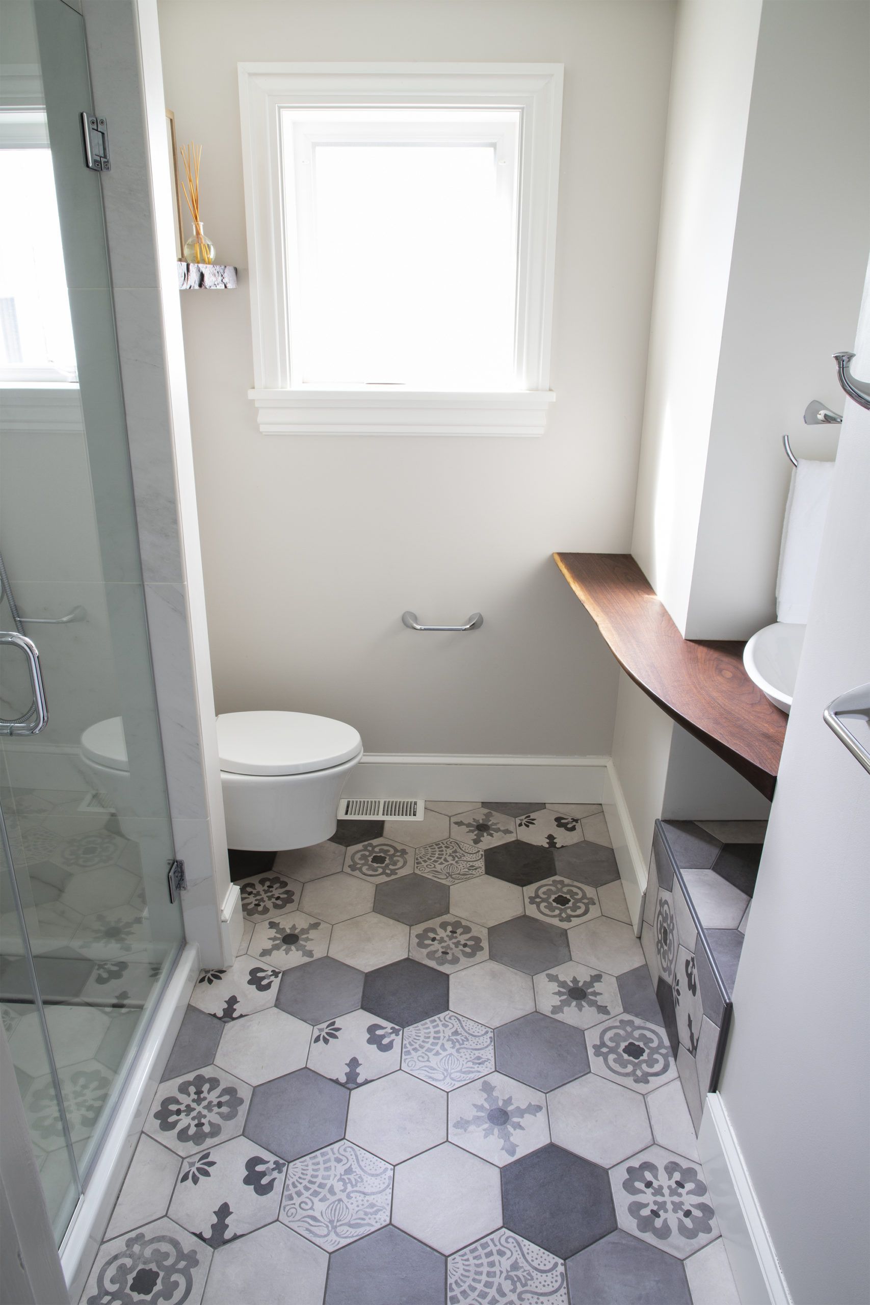 A bathroom with a toilet , sink , and shower.