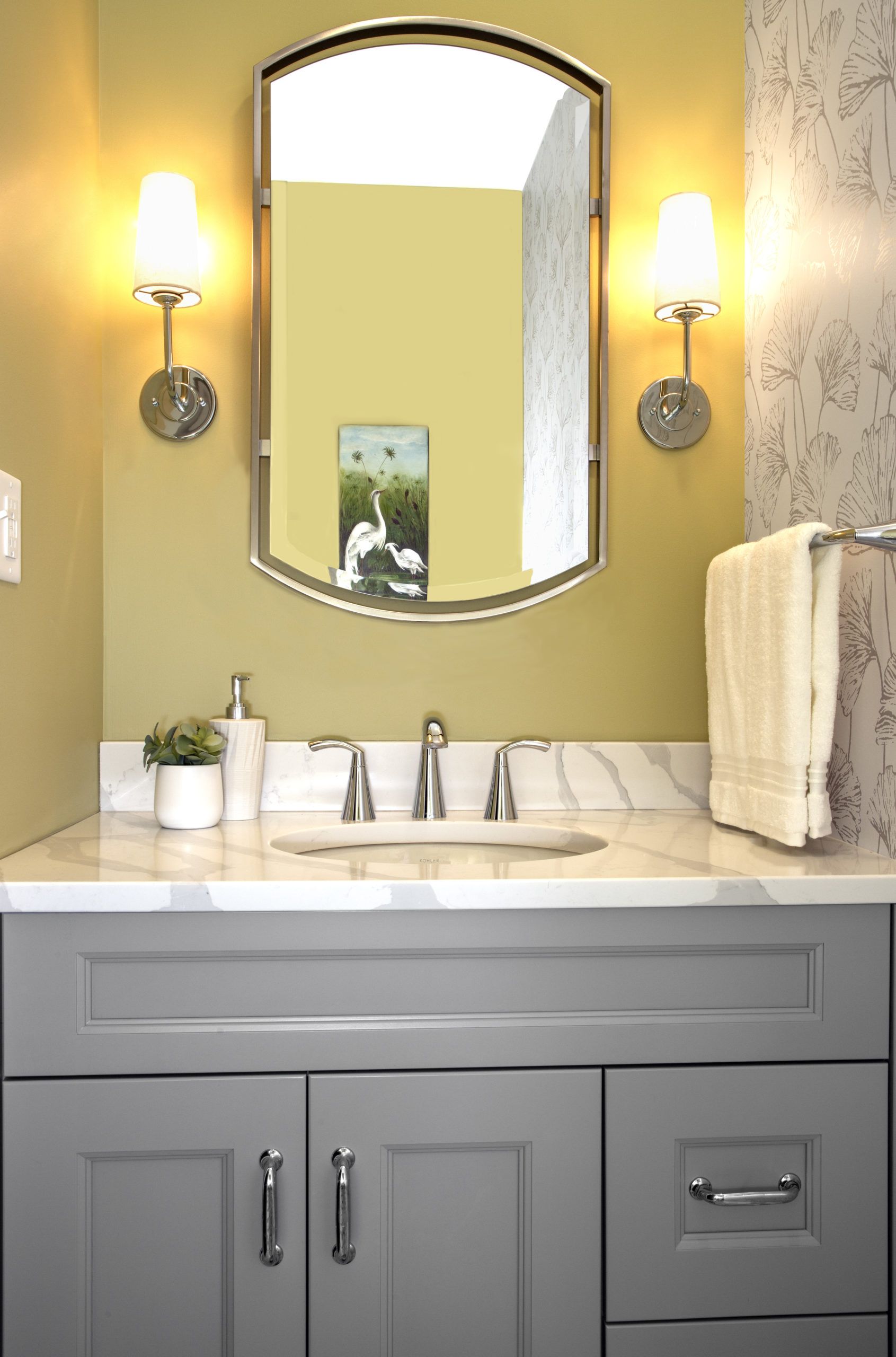 A bathroom with a sink and a mirror on the wall.