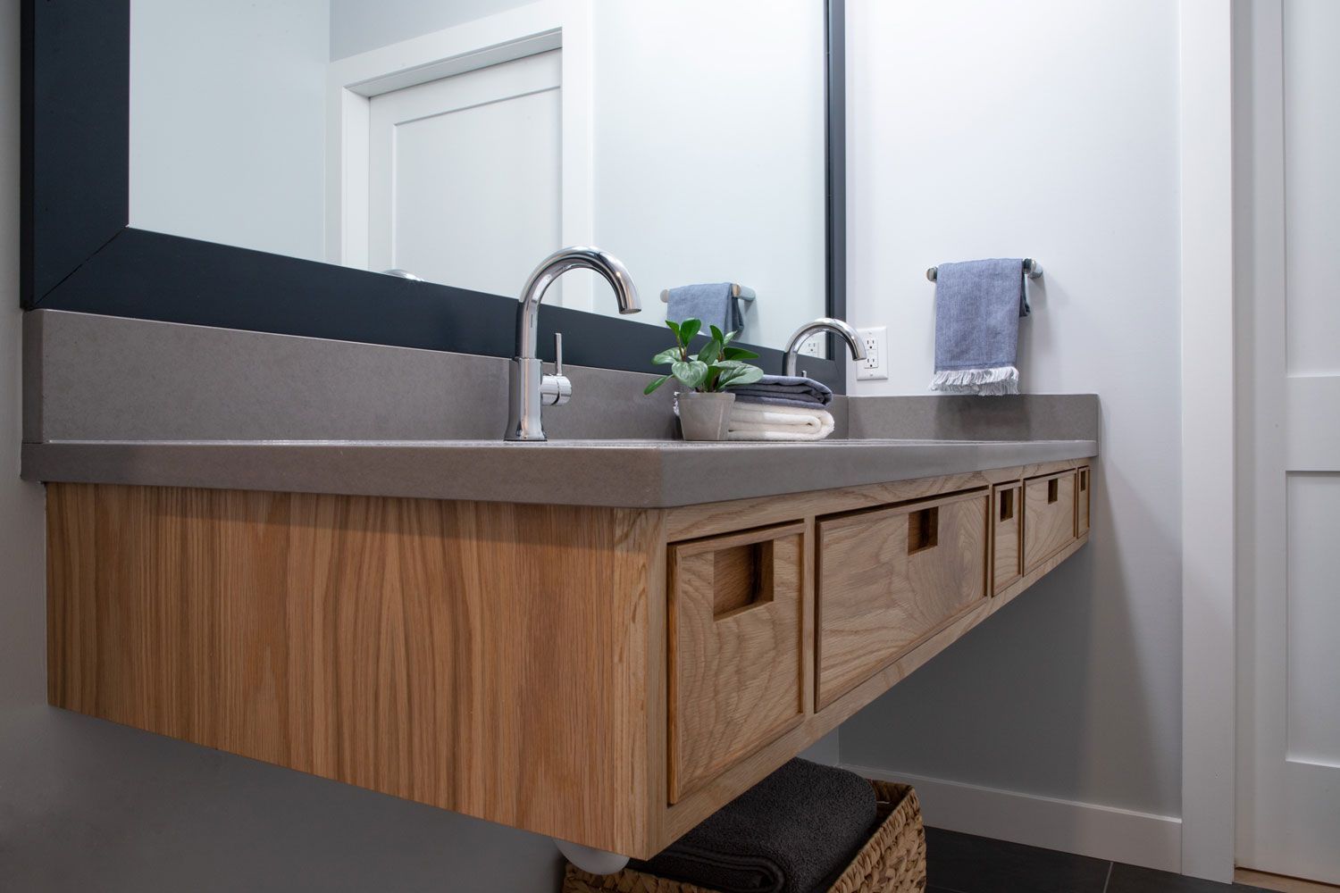 An ADA complaint bathroom with a sink , mirror and drawers.