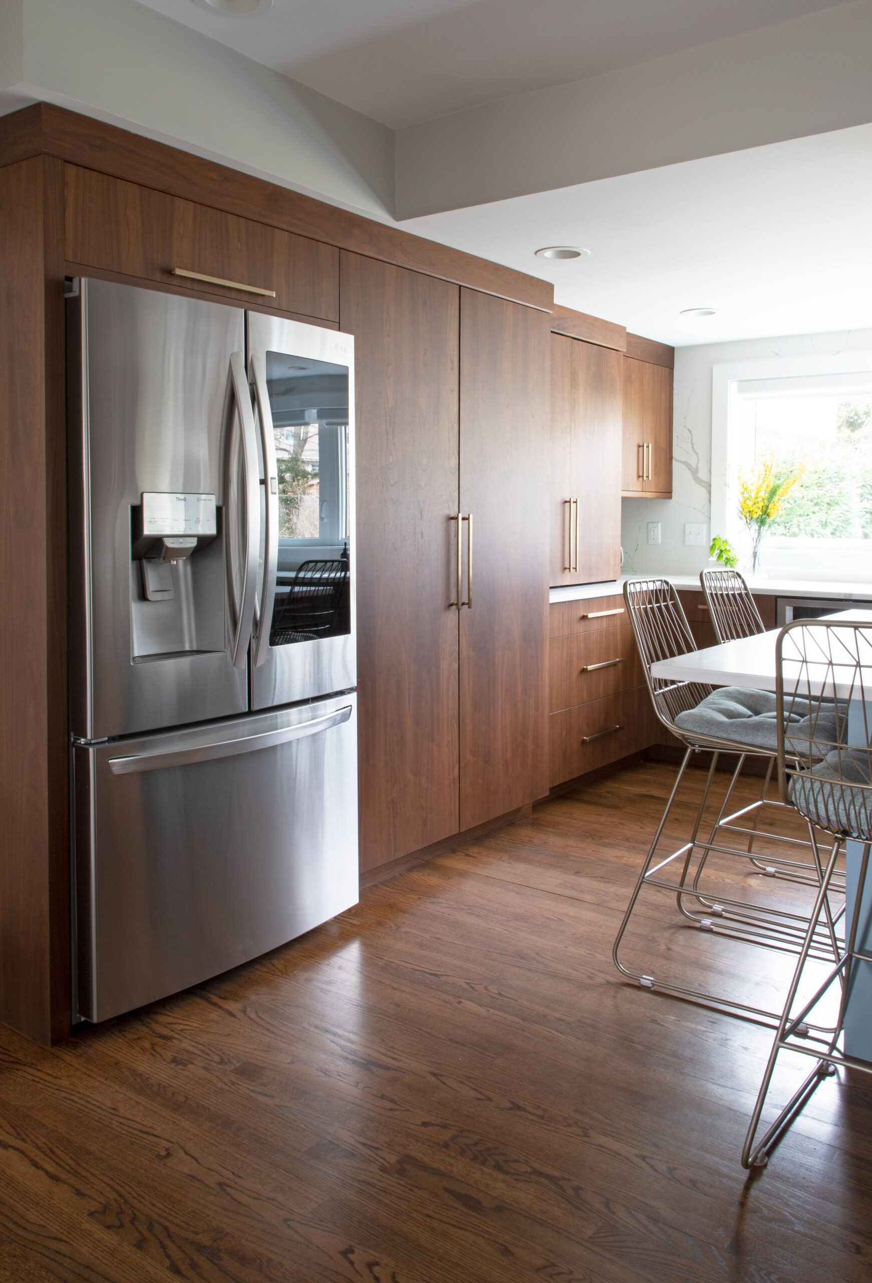 A kitchen with stainless steel appliances and wooden cabinets.
