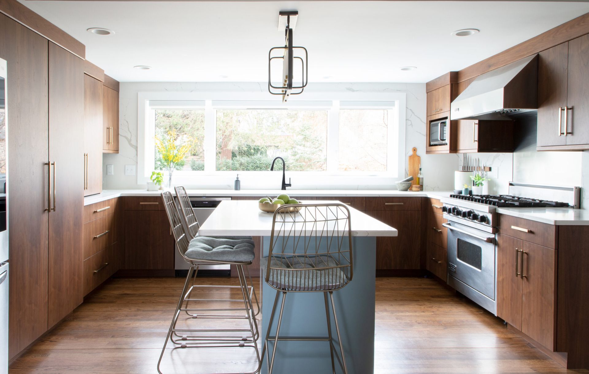 A kitchen with stainless steel appliances and wooden cabinets