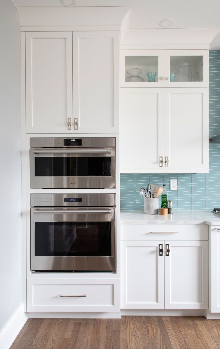 A kitchen with white cabinets and stainless steel appliances.