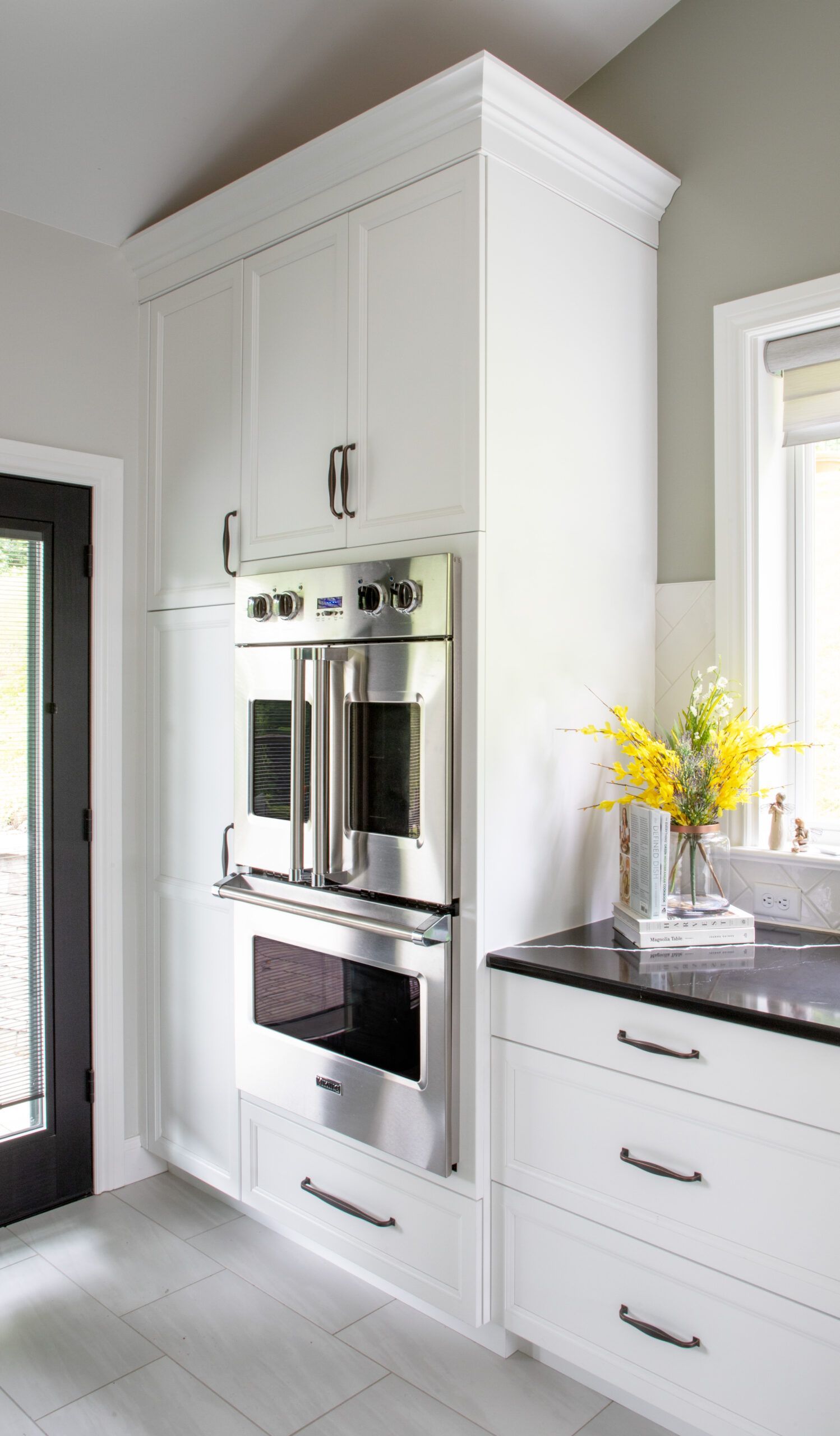 A kitchen with white cabinets and stainless steel appliances.