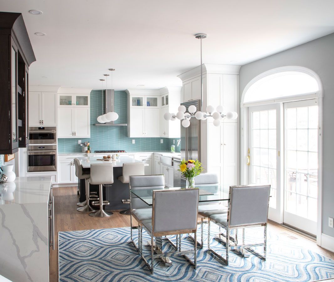 A kitchen and dining room with a table and chairs