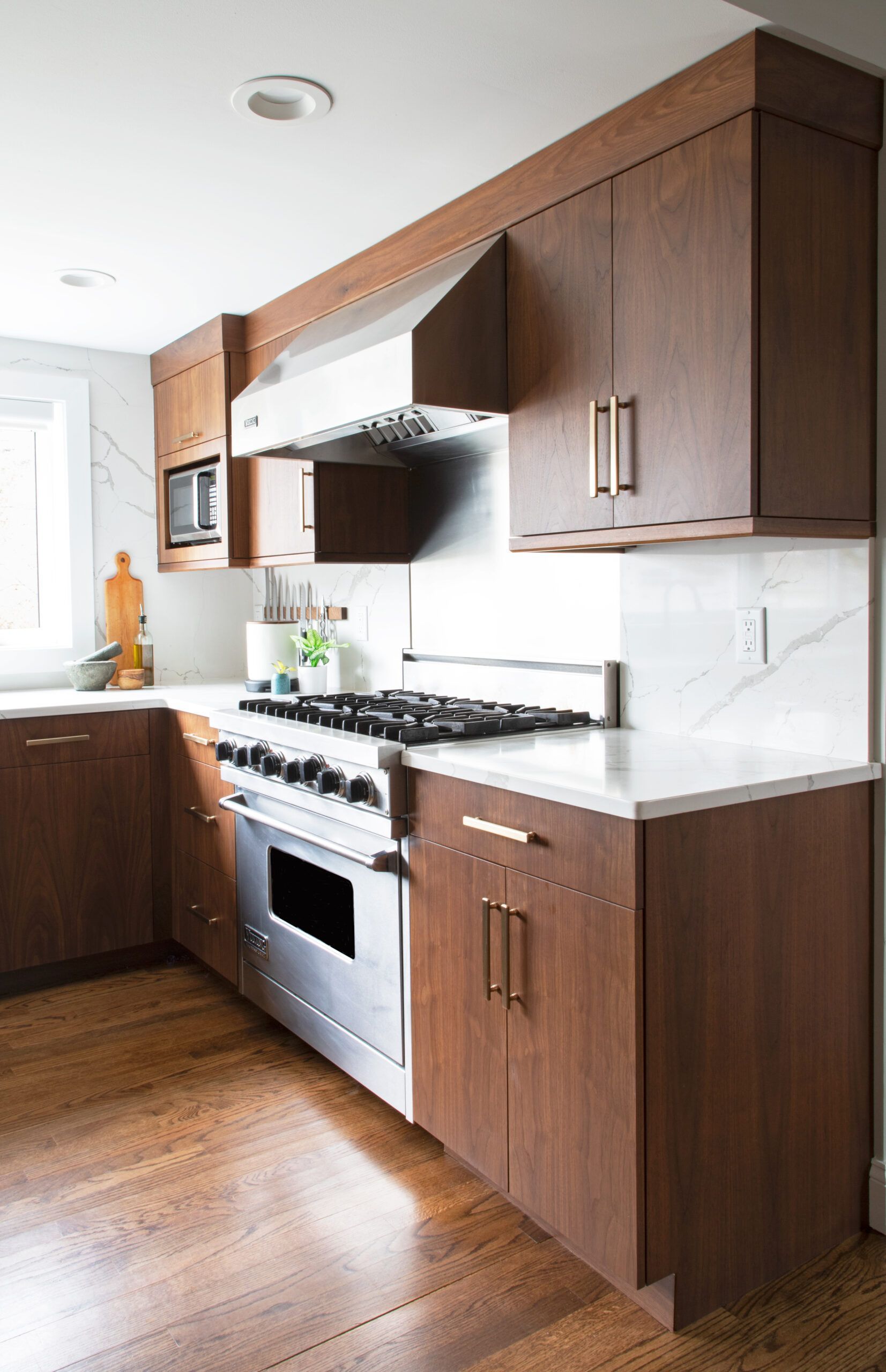 A kitchen with stainless steel appliances and wooden cabinets.