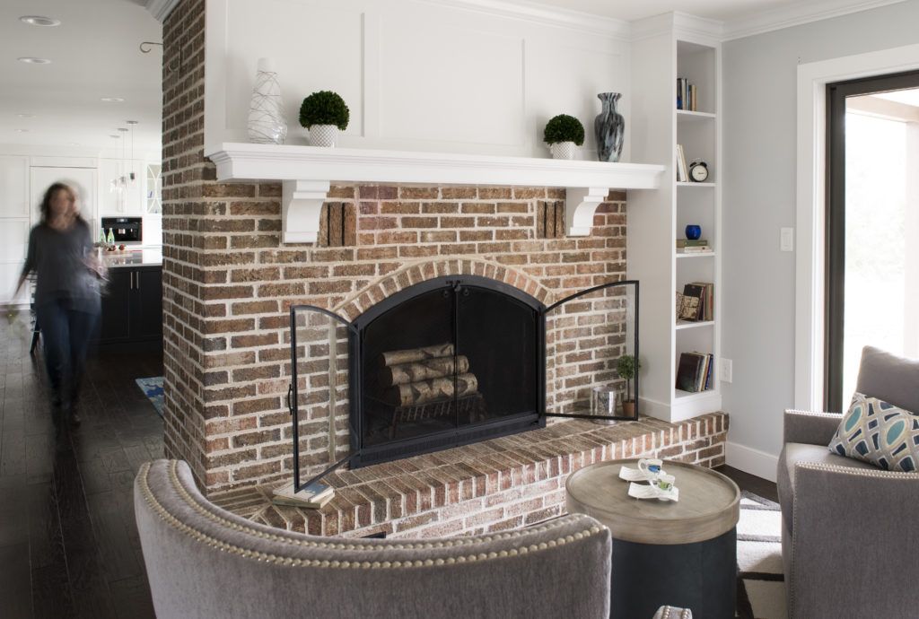 There is a fireplace in the middle of the living room.