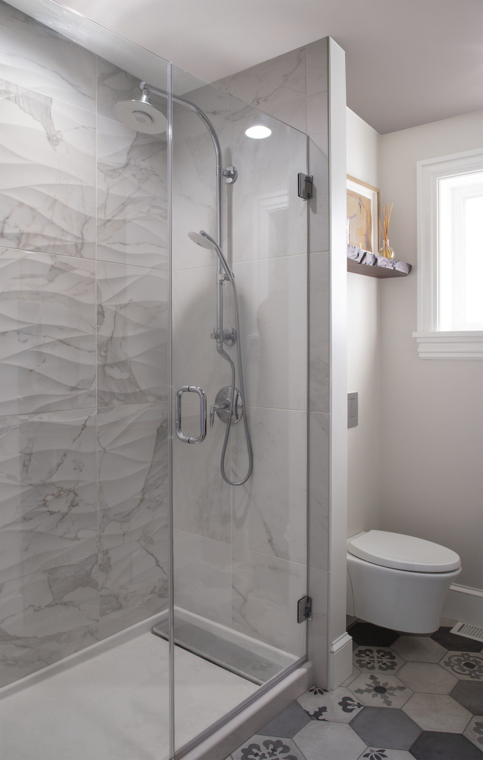 A bathroom with a walk in shower and a toilet.