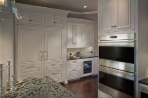 A kitchen with white cabinets and stainless steel appliances.