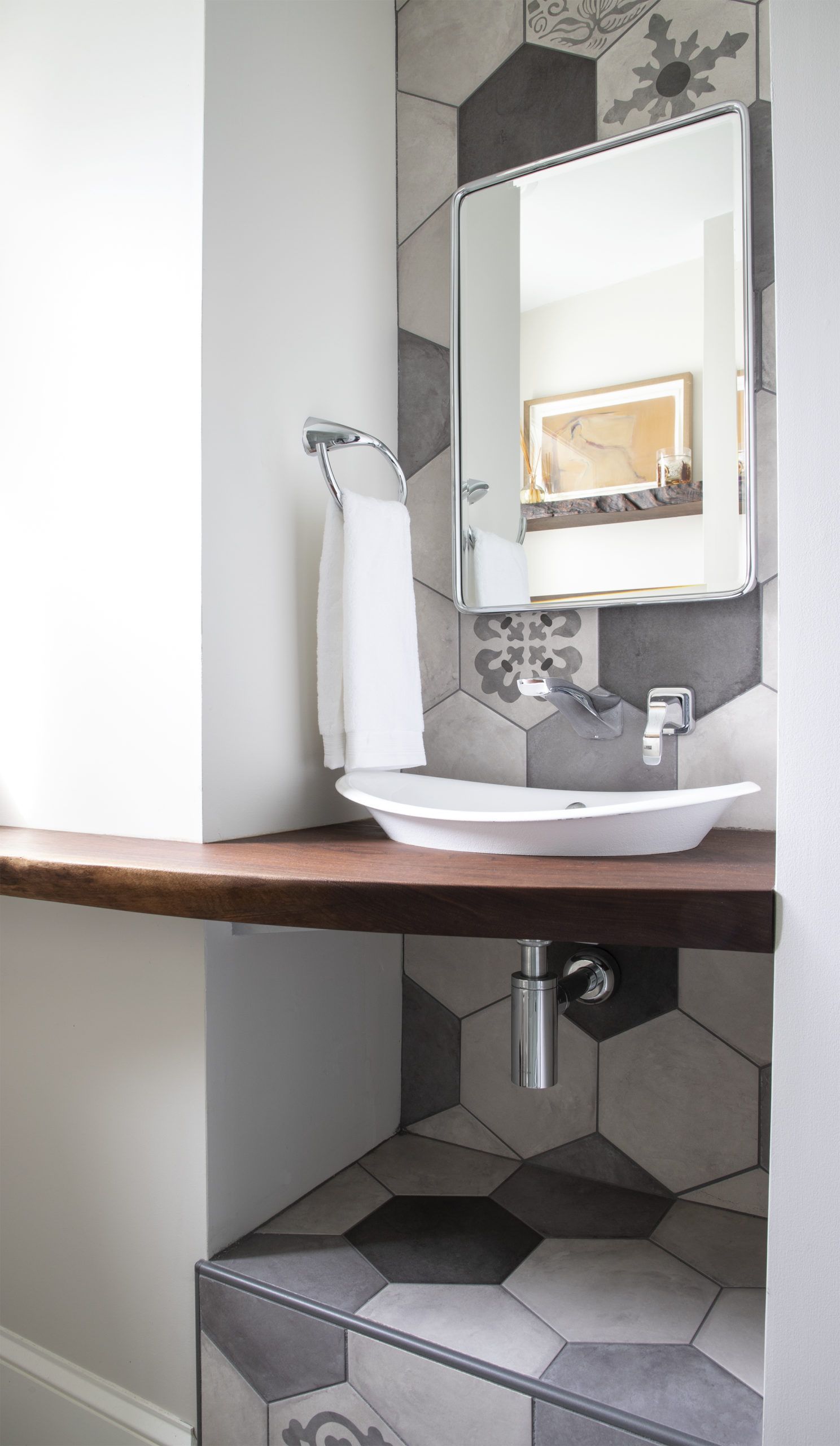 A bathroom with a sink and a mirror on the wall.