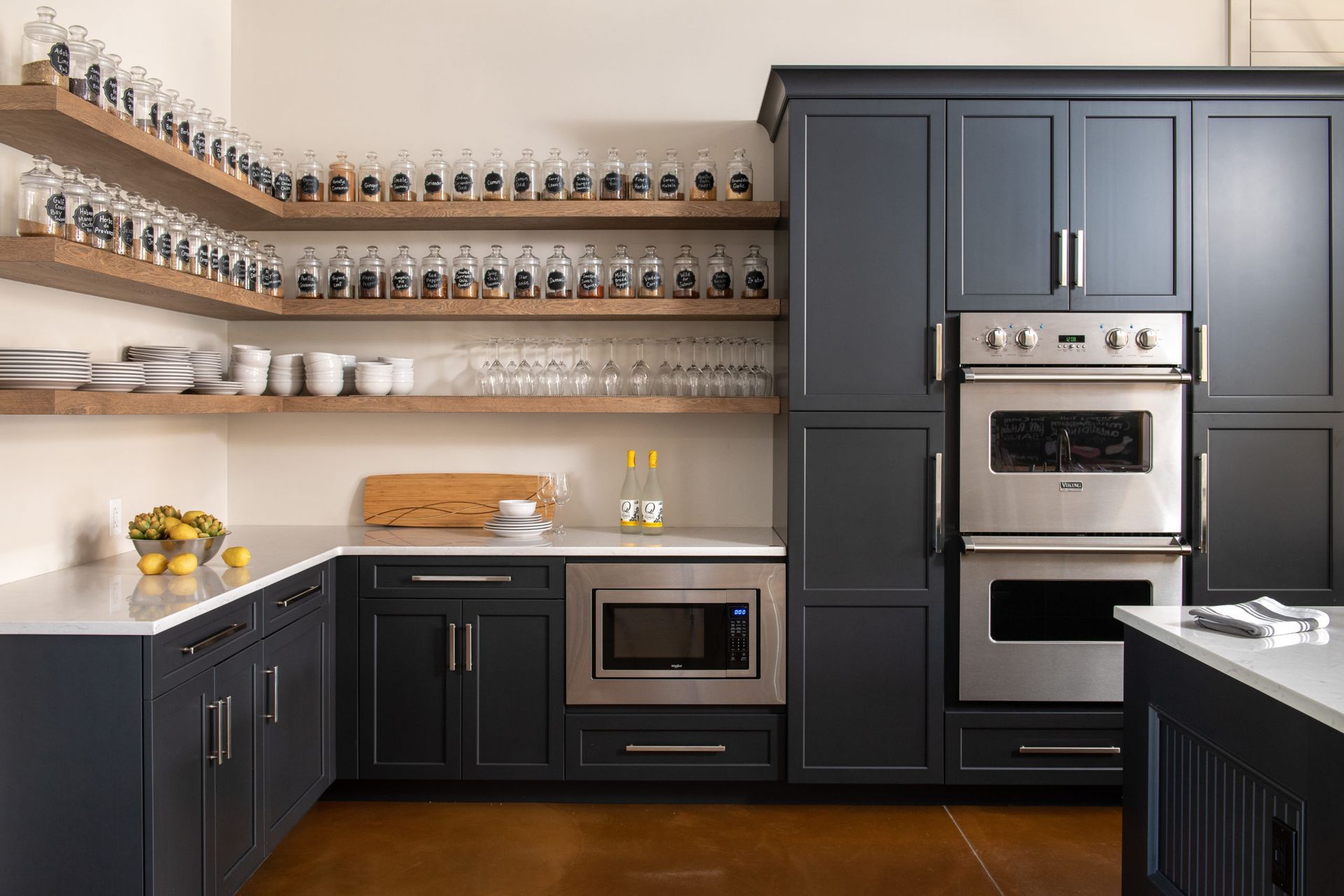 A kitchen with black cabinets and stainless steel appliances.