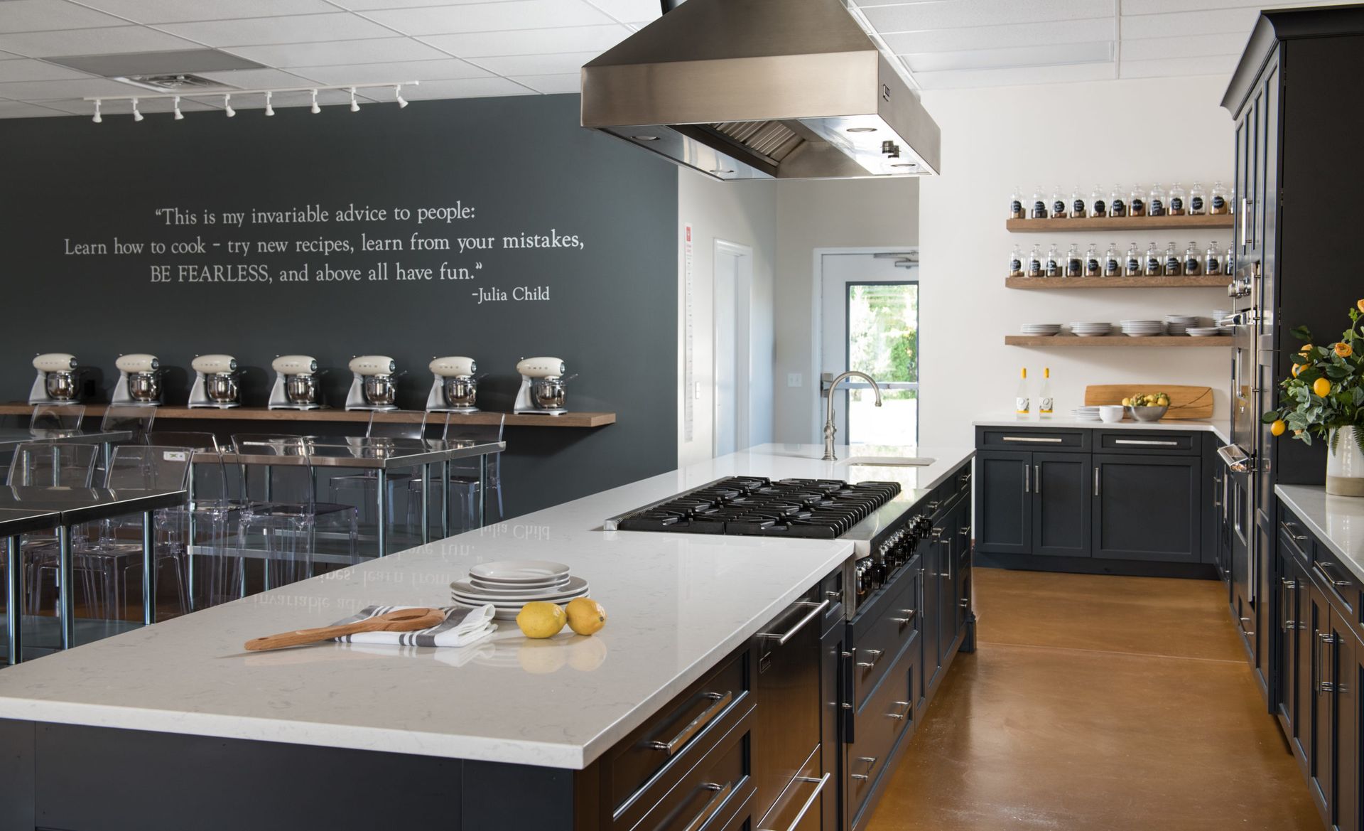 A kitchen with a large island and a stove top oven