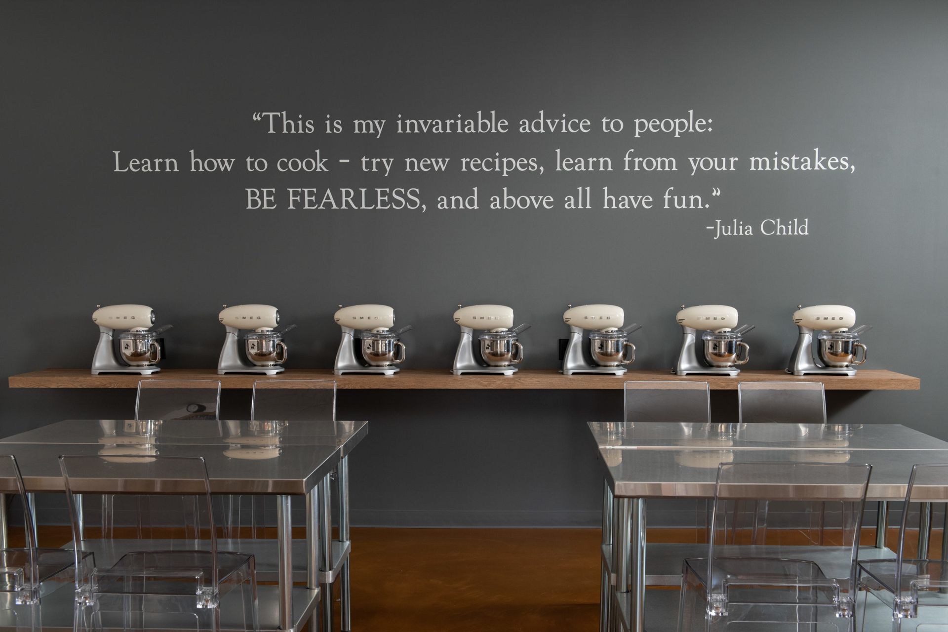 A kitchen with mixers and a quote on the wall