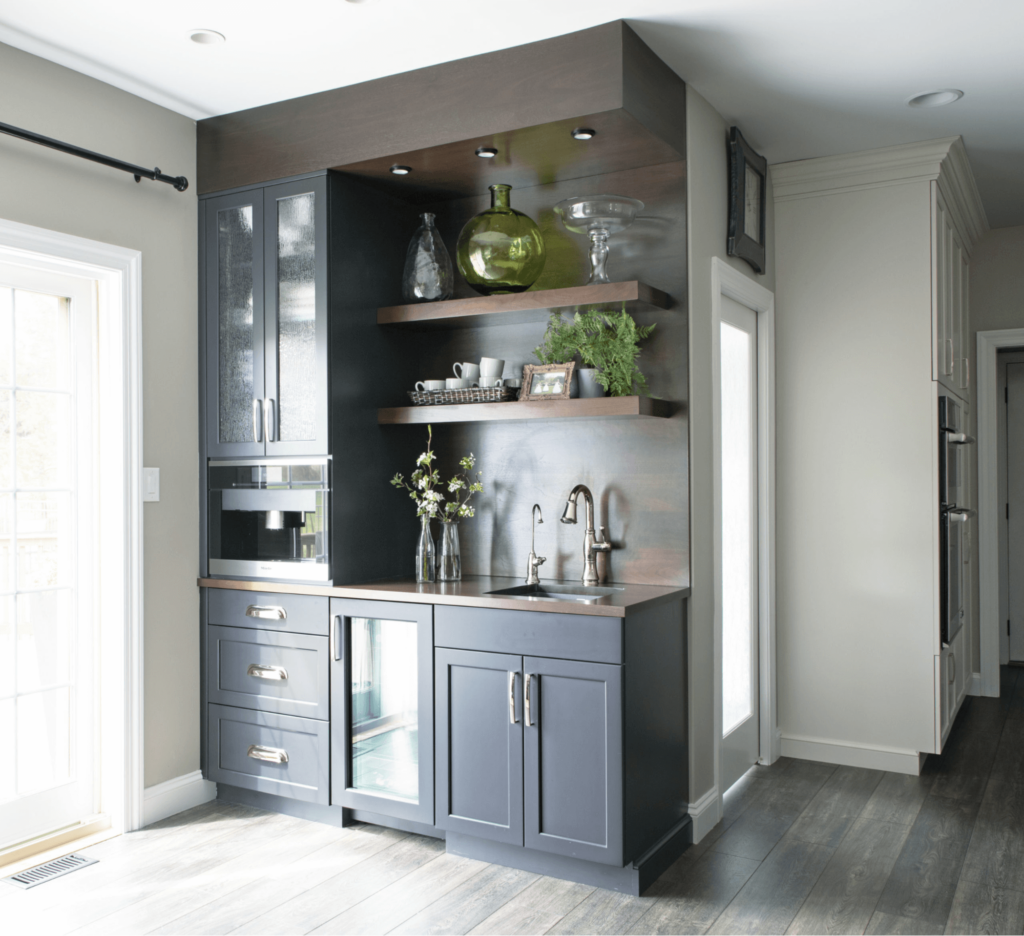 A kitchen with gray cabinets and a sink