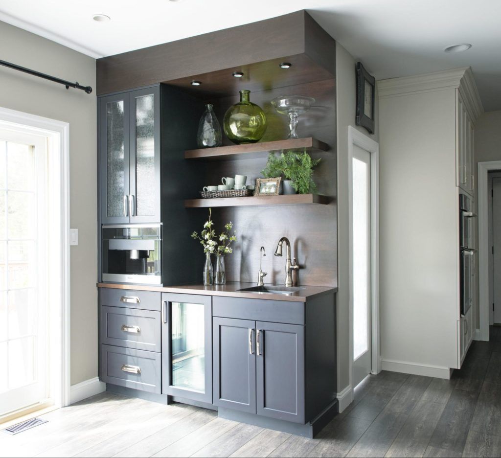 A kitchen with black cabinets and a sink