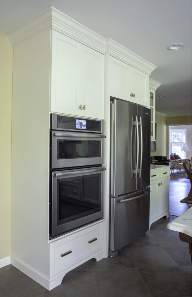 A kitchen with stainless steel appliances and white cabinets