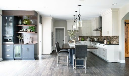 A kitchen with a table and chairs in it