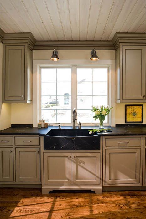 A kitchen with a sink and a large window