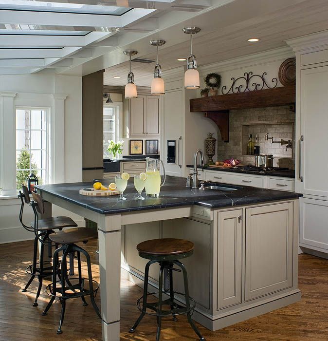 A kitchen with white cabinets and a large island