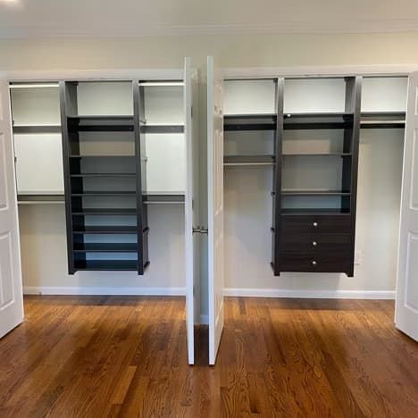 A reach-in closet with two shelves and two drawers.