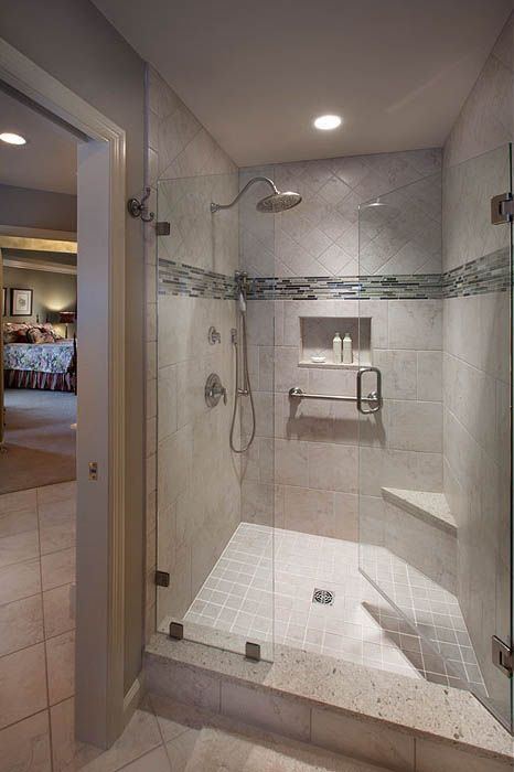 An ADA complaint bathroom with a walk in shower with a glass door