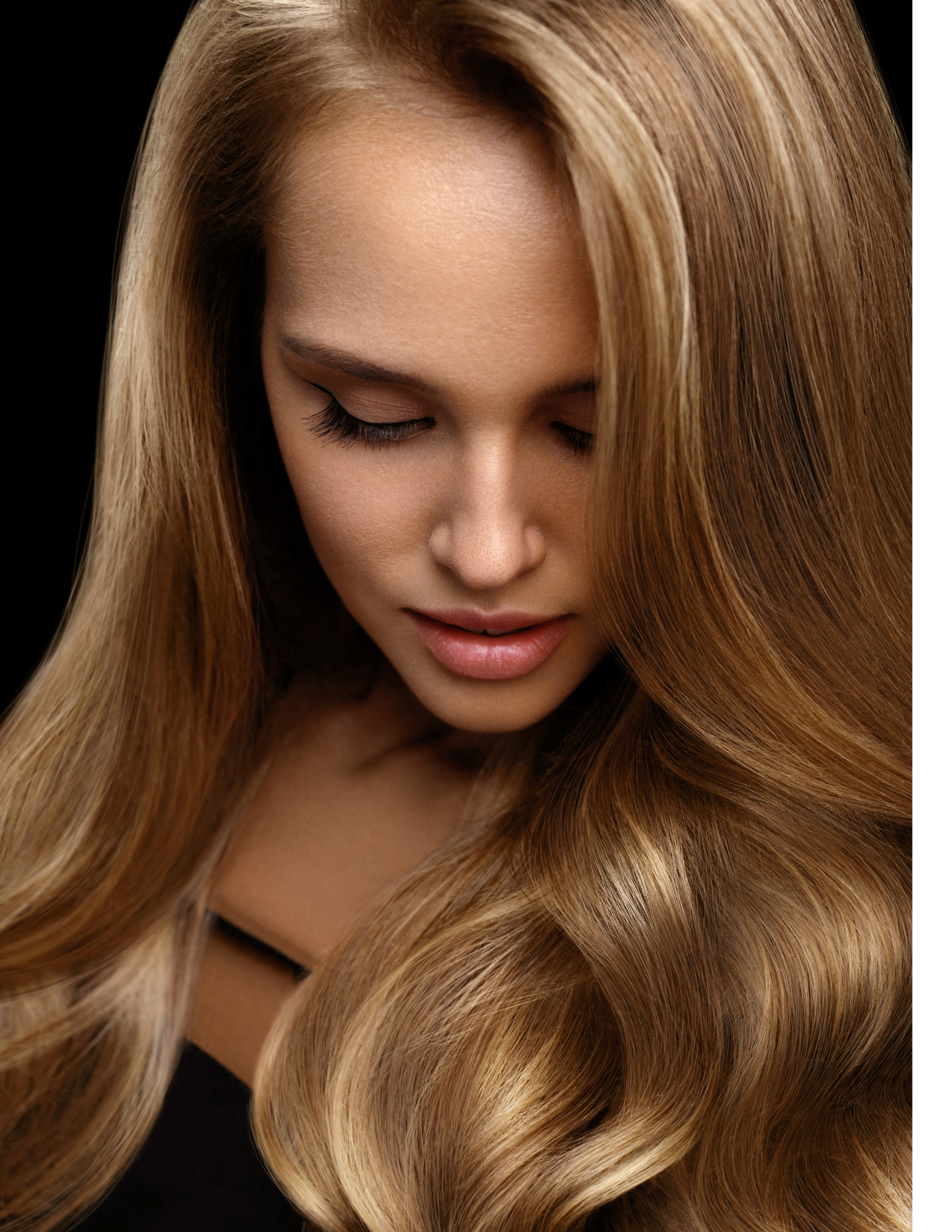 A woman with long blonde hair is wearing a black top.