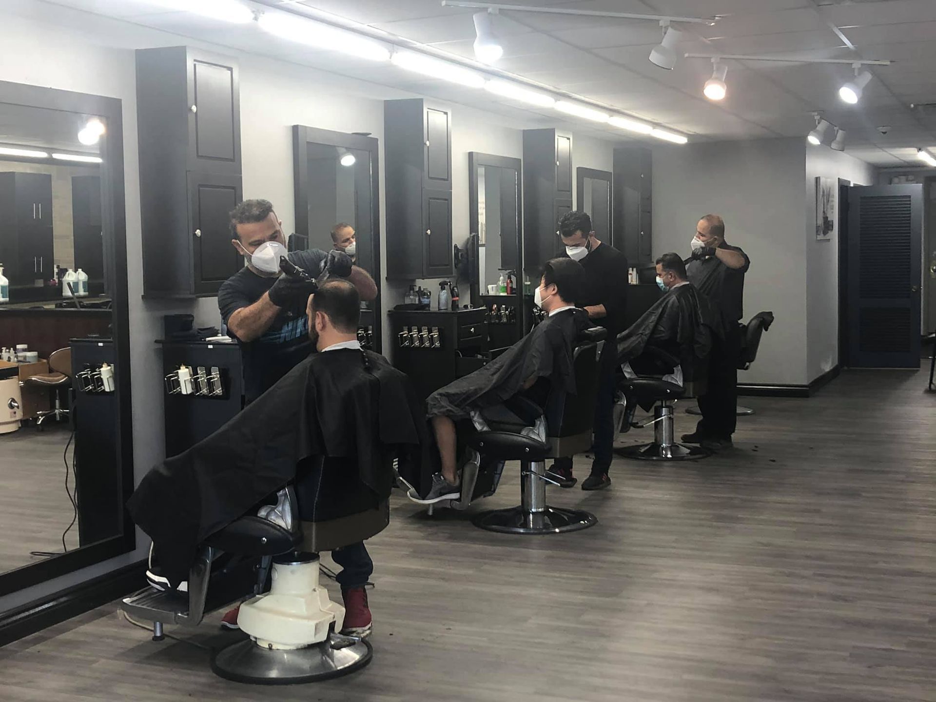 The barber team cutting men's hair.